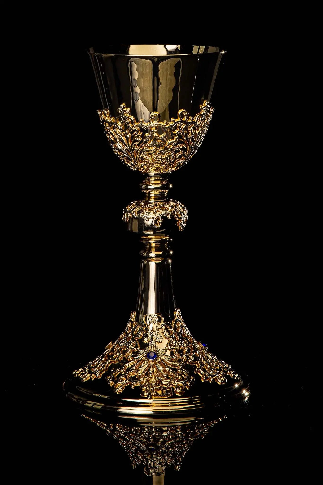 Handmade gold-plated chalice with floral ornamentation on the cup, knop, and base, adorned with blue imitation sapphires.