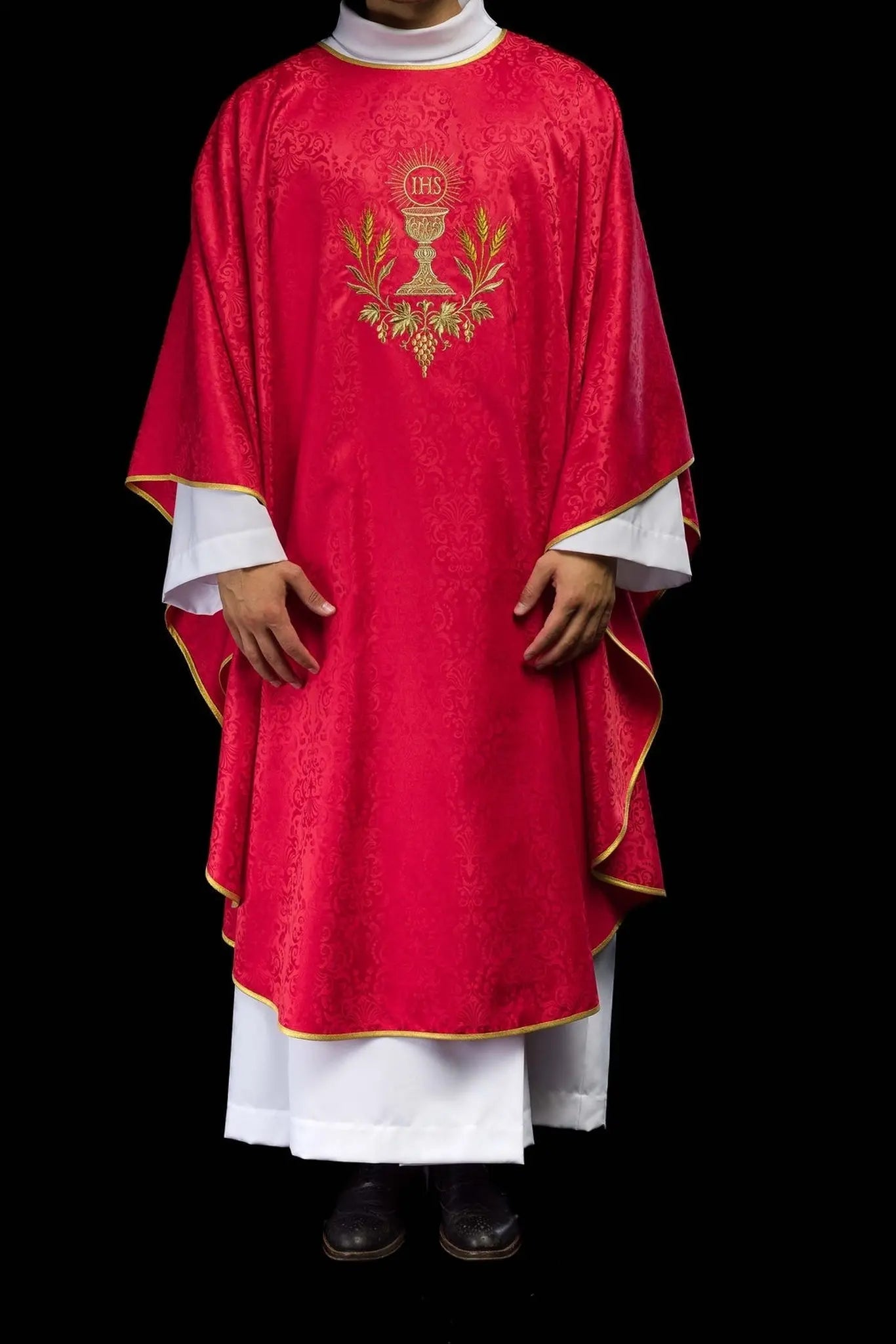 Red liturgical chasuble with an embroidered chalice and host on jacquard fabric