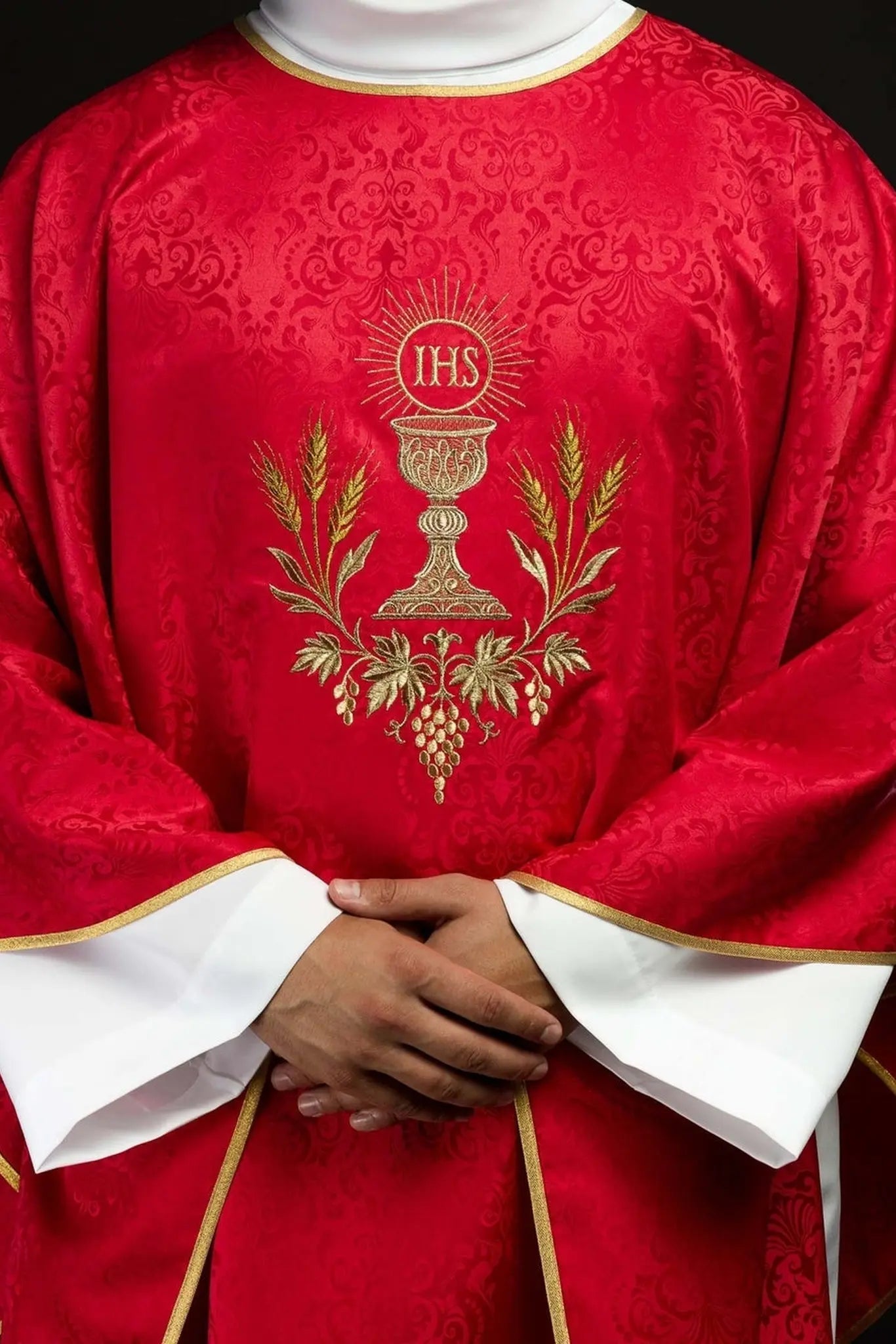 Red liturgical chasuble with an embroidered chalice and host on jacquard fabric