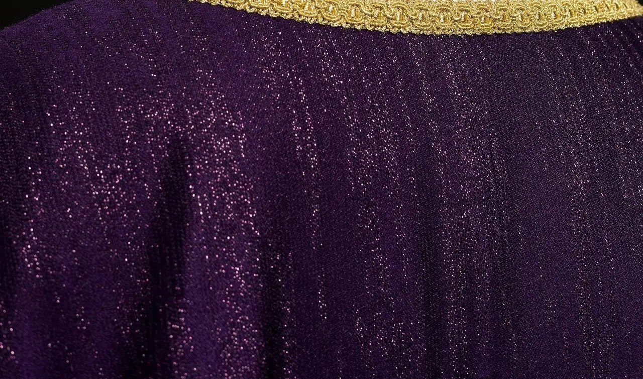 Purple liturgical chasuble with an embroidered cross motif on decorative fabric