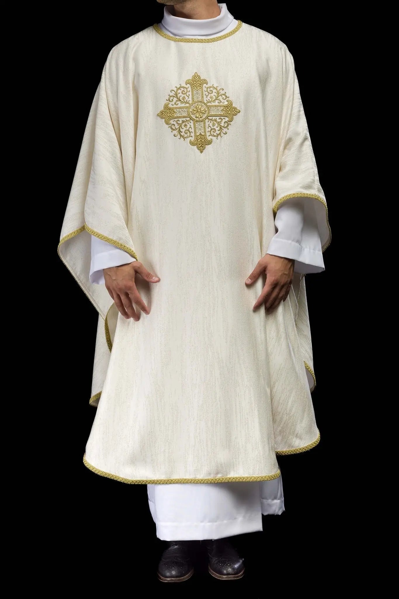 Ecru chasuble with embroidered cross motif on decorative fabric