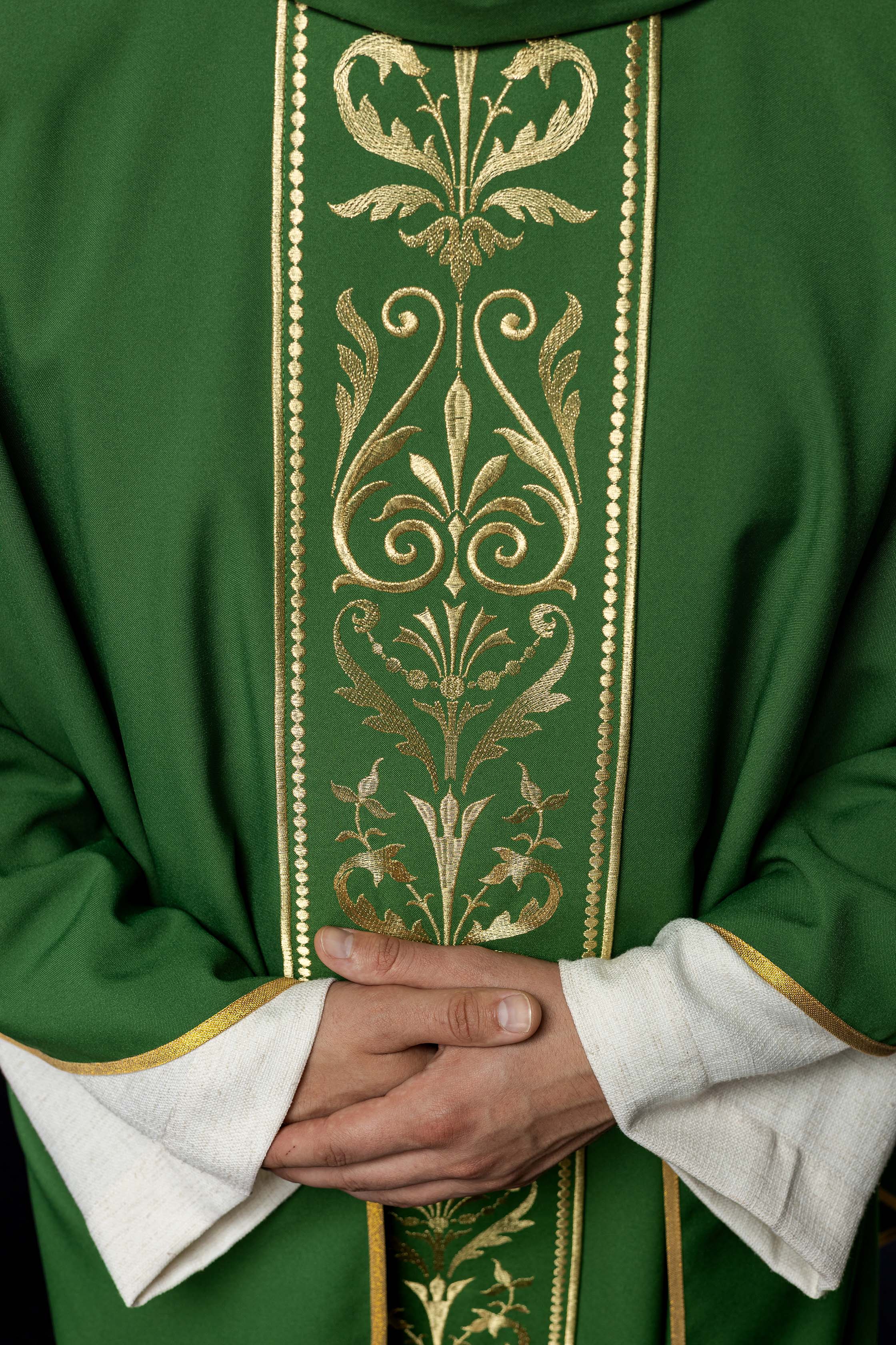 Green liturgical chasuble decorated with gold embroidered belt