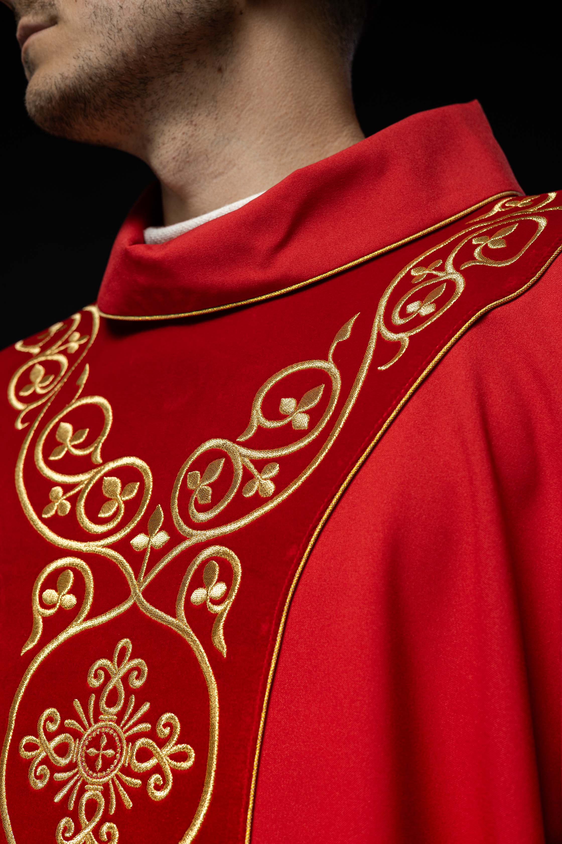 Red liturgical chasuble decorated with embroidery on velvet