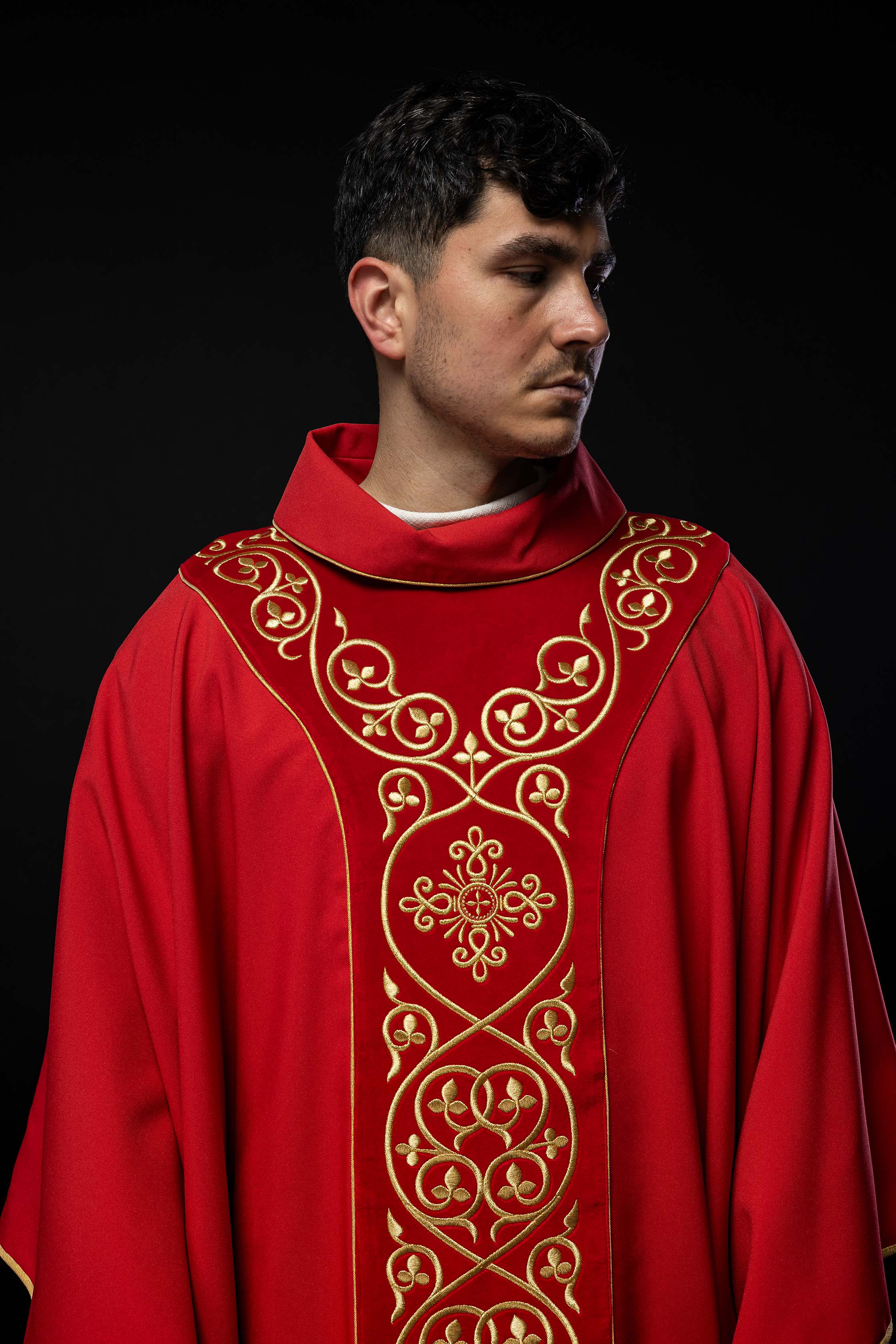 Red liturgical chasuble decorated with embroidery on velvet