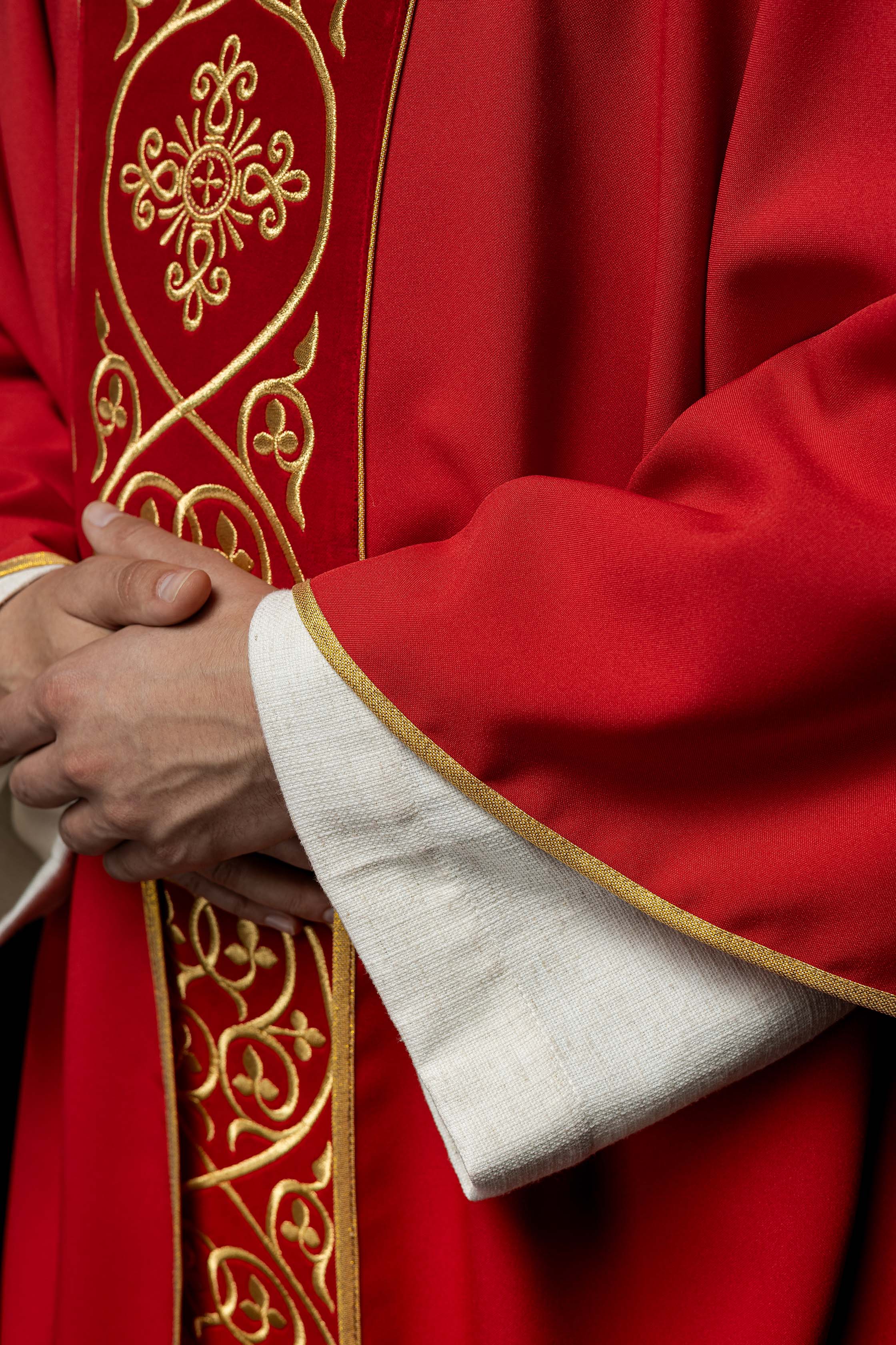 Red liturgical chasuble decorated with embroidery on velvet