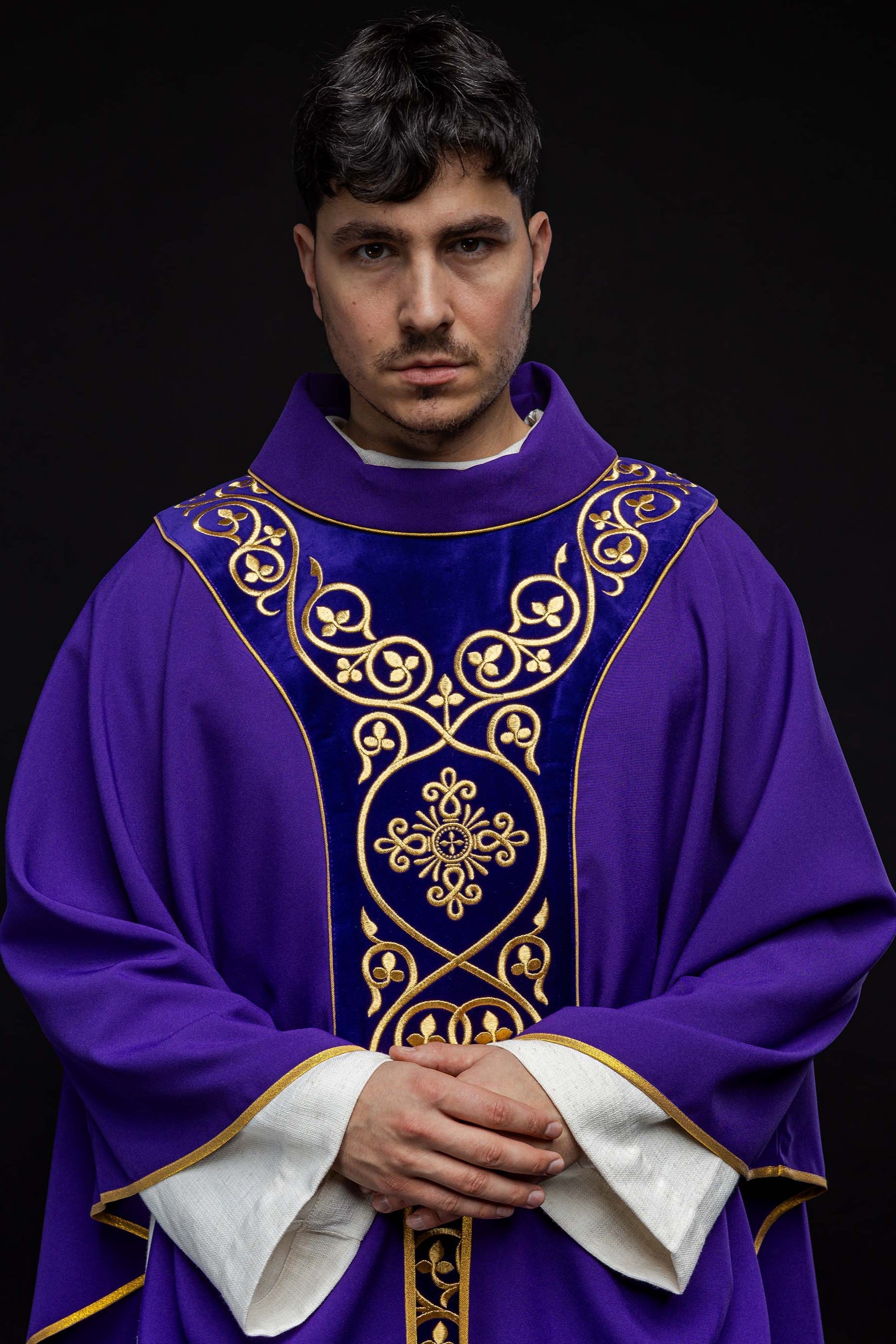 Purple liturgical chasuble decorated with embroidery on velvet