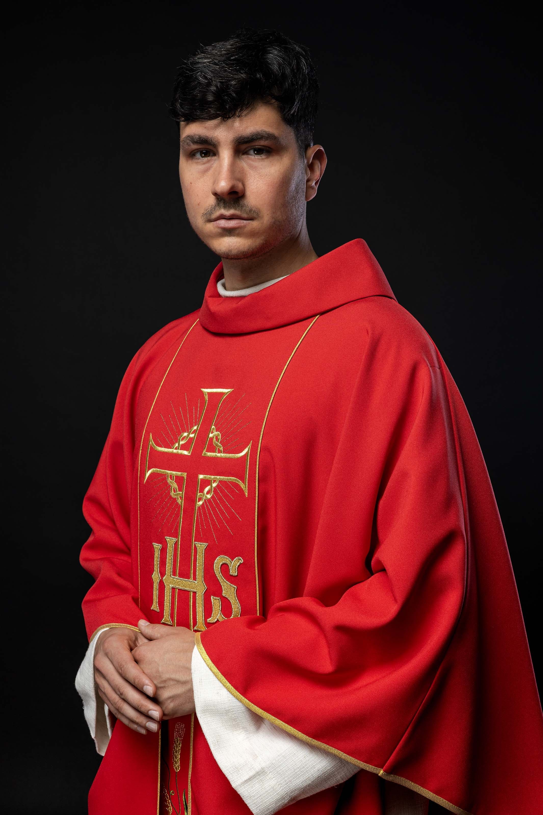 Red chasuble with decorated gold belt with IHS and ears