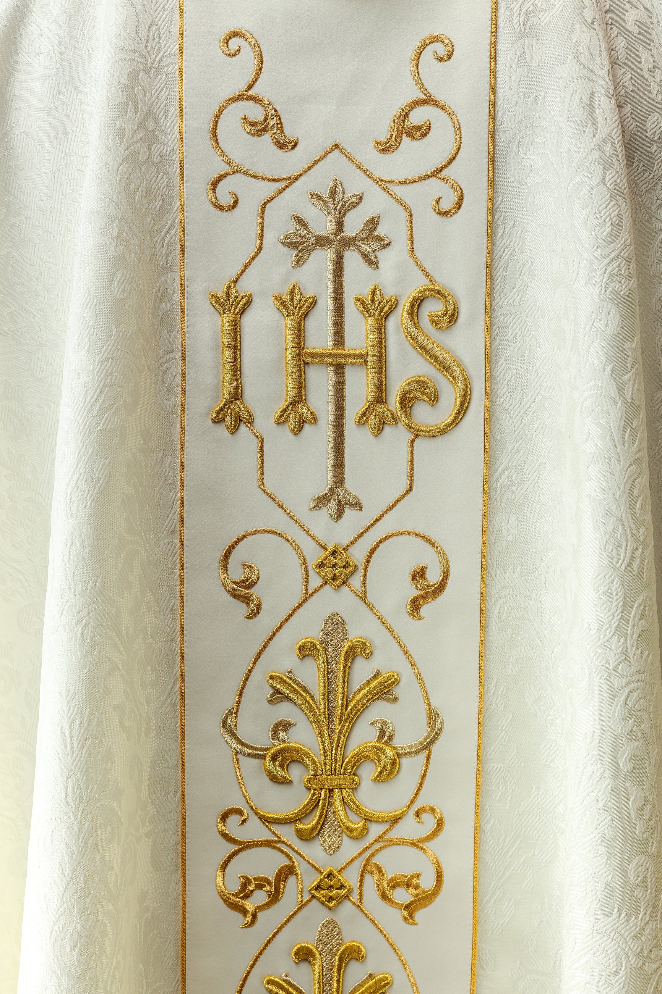 Ecru chasuble embroidered on decorative fabric with IHS symbol