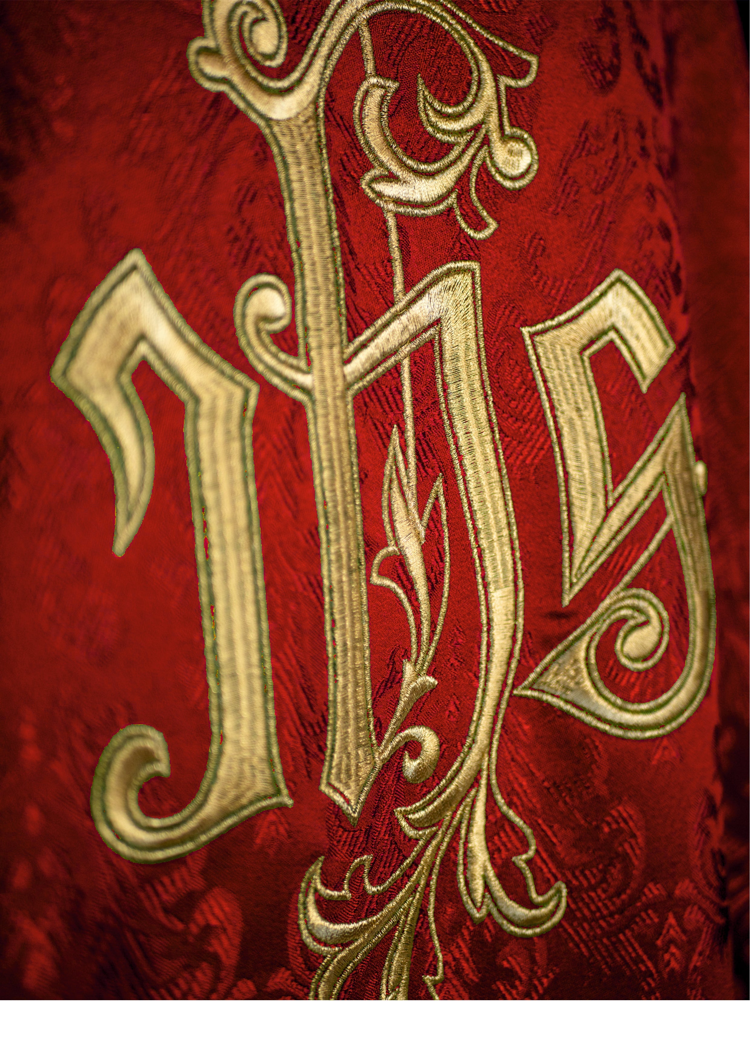 Red chasuble with embroidered IHS motif on decorative fabric