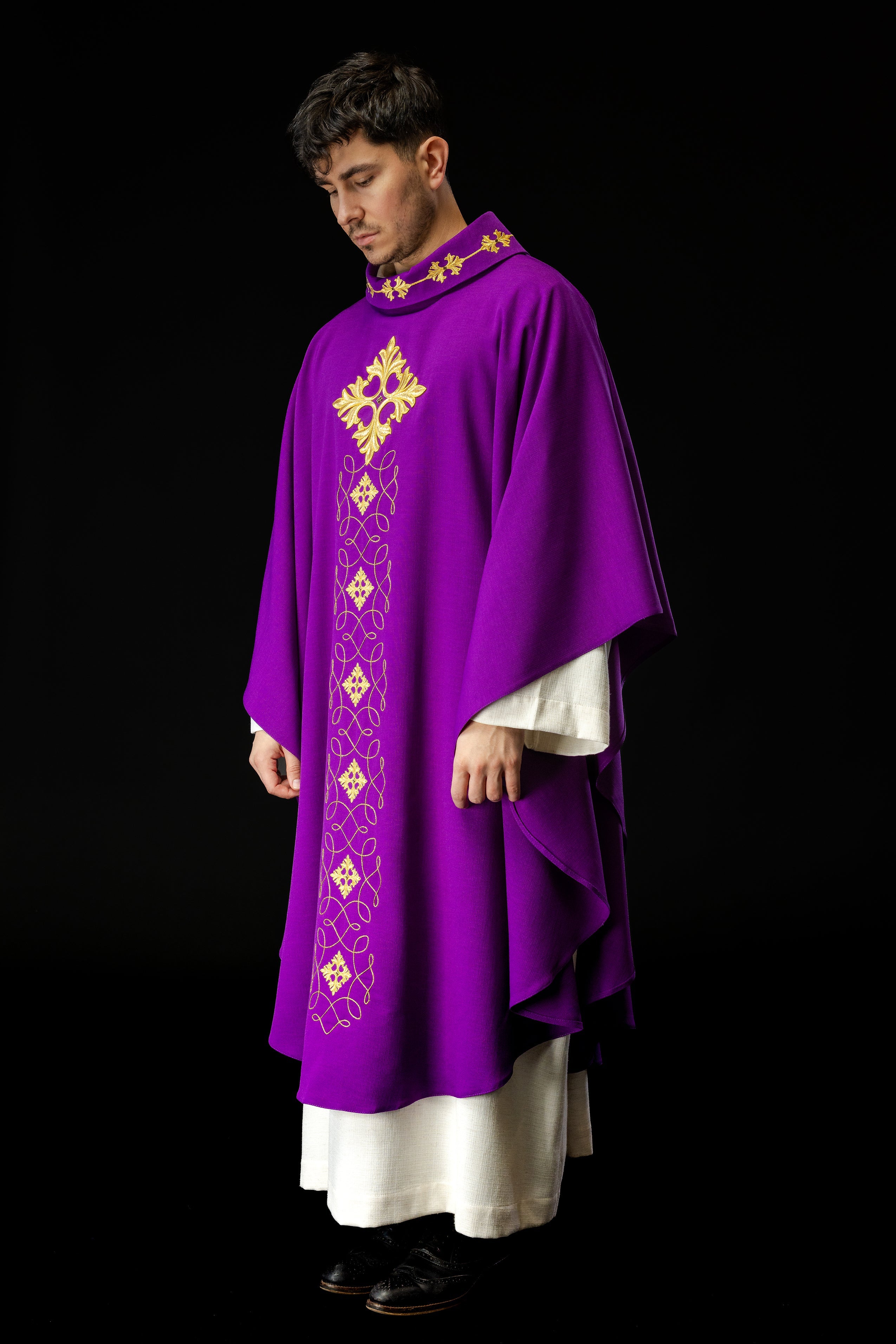 Purple chasuble richly embroidered with string and stones