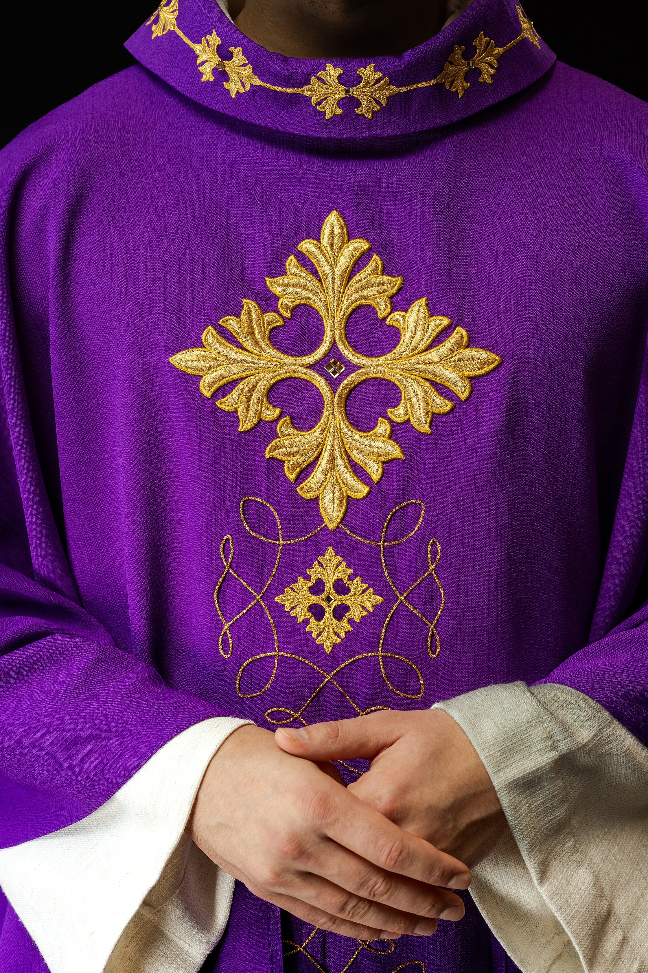 Purple chasuble richly embroidered with string and stones