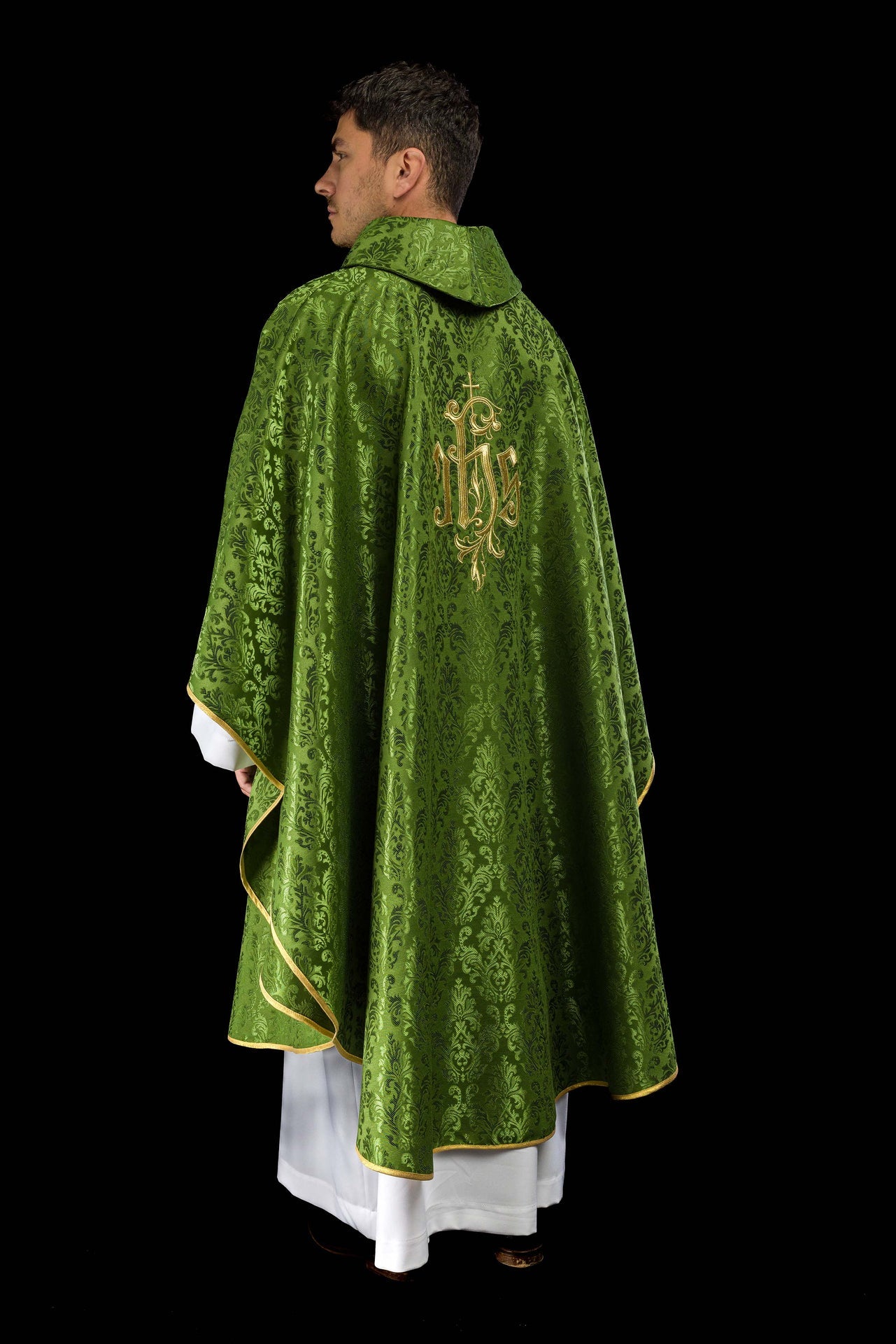 Green chasuble with embroidered IHS motif on decorative fabric