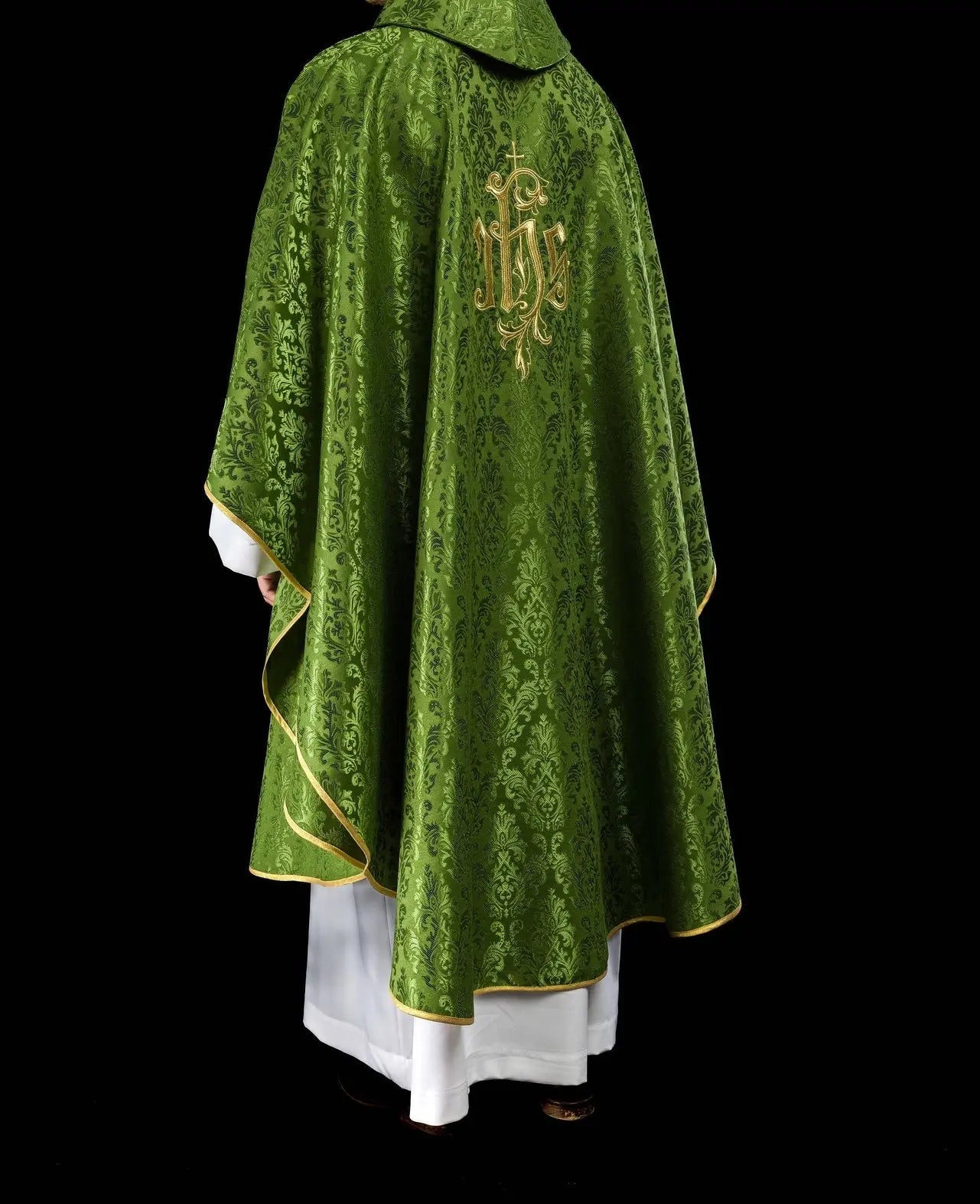 Green chasuble with embroidered IHS motif on decorative fabric