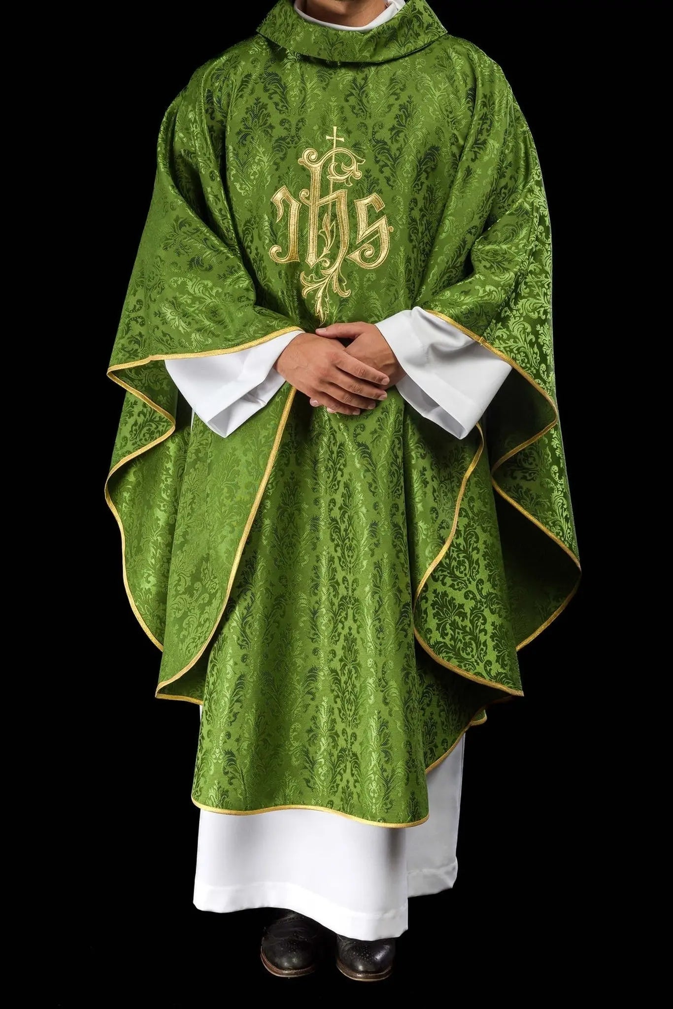 Green chasuble with embroidered IHS motif on decorative fabric