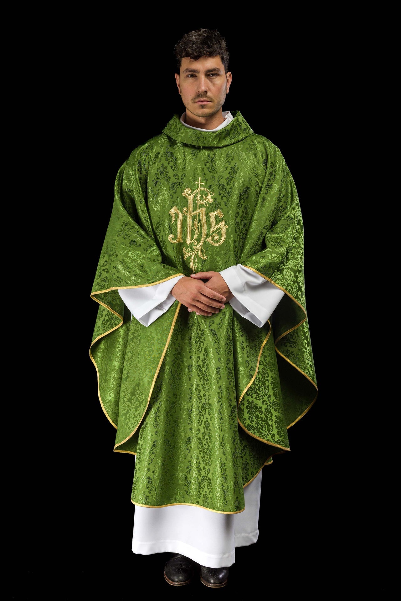 Green chasuble with embroidered IHS motif on decorative fabric