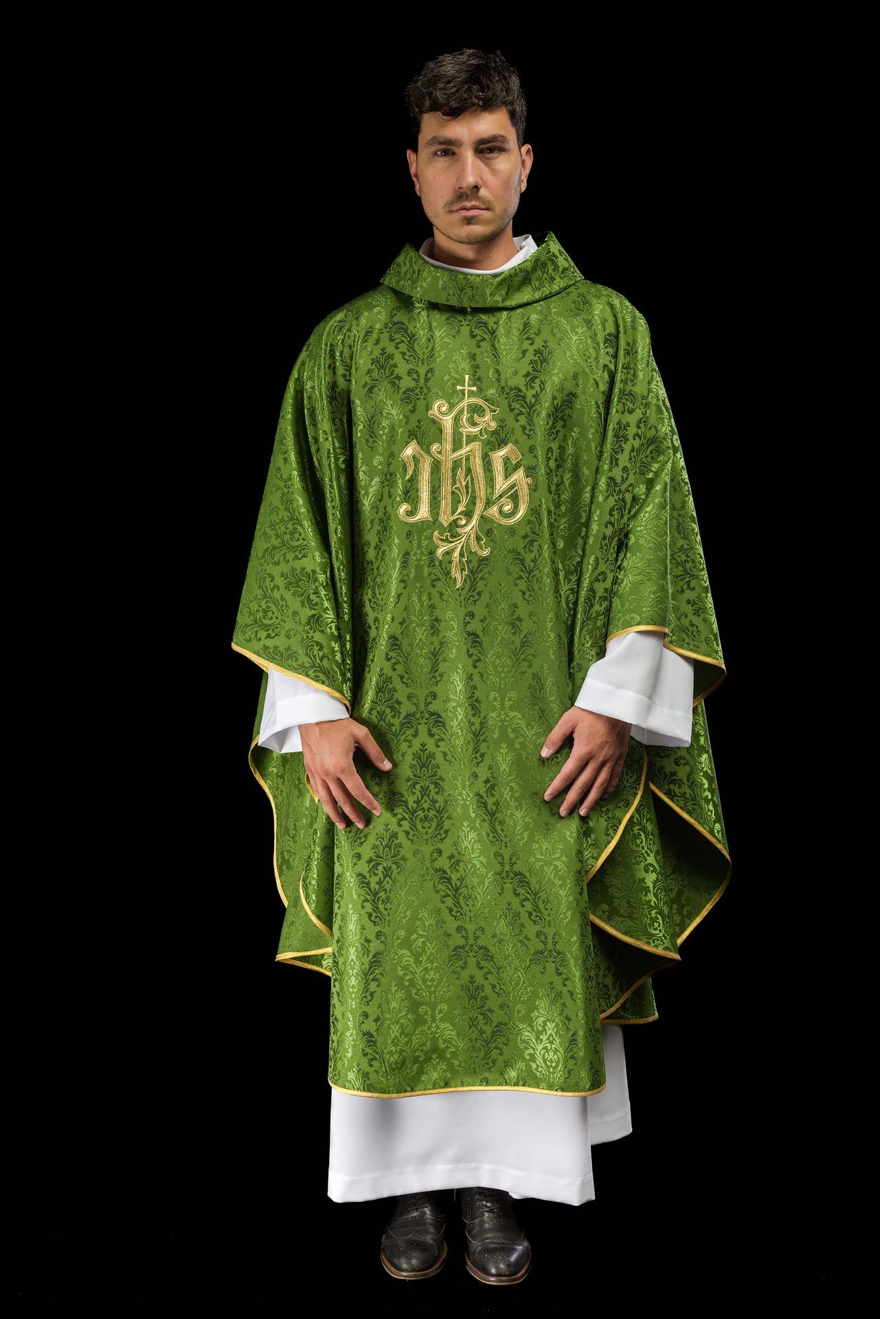 Green chasuble with embroidered IHS motif on decorative fabric