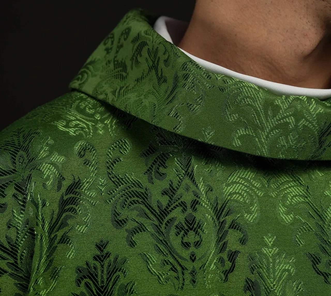 Green chasuble with embroidered IHS motif on decorative fabric