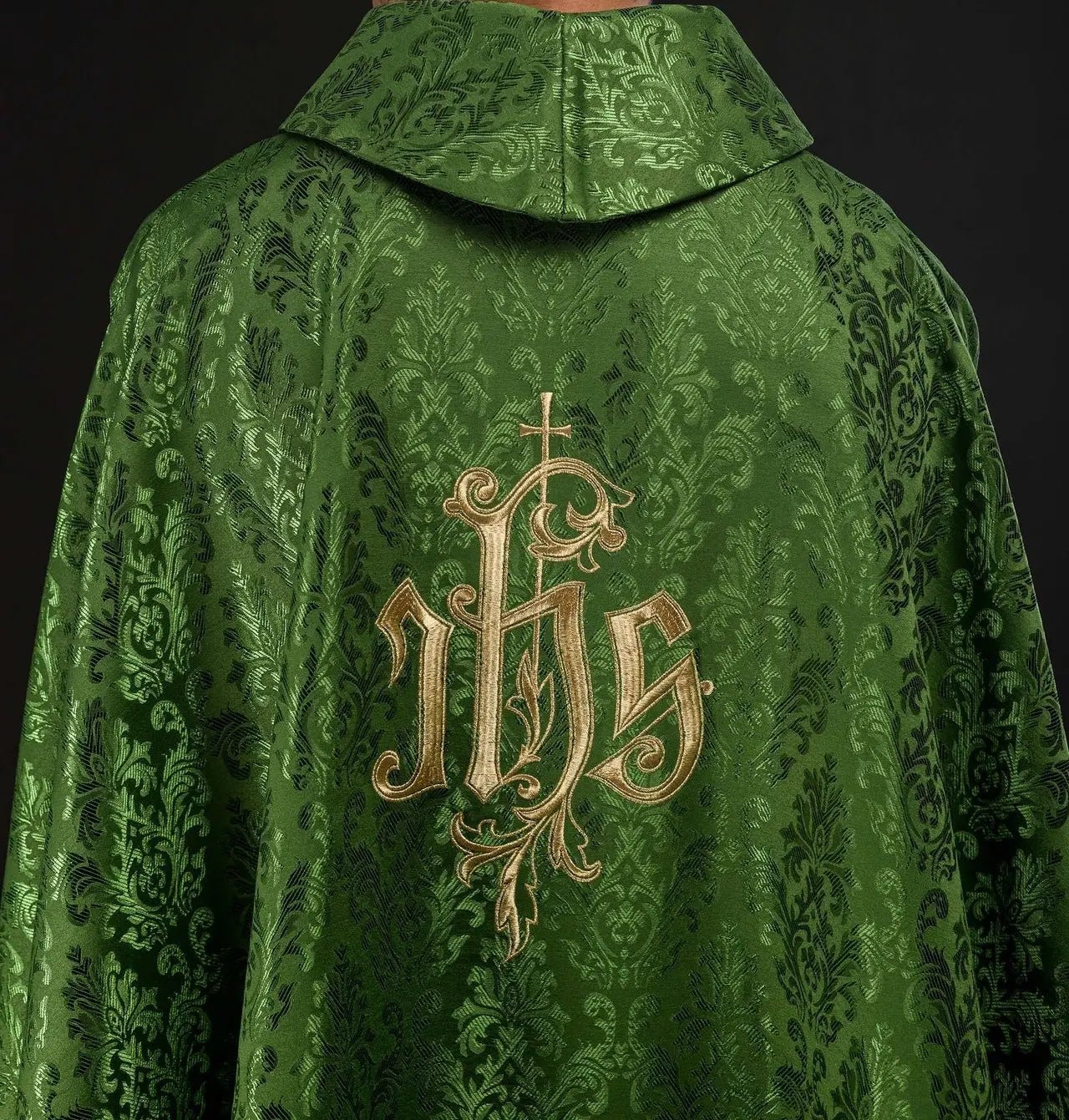 Green chasuble with embroidered IHS motif on decorative fabric