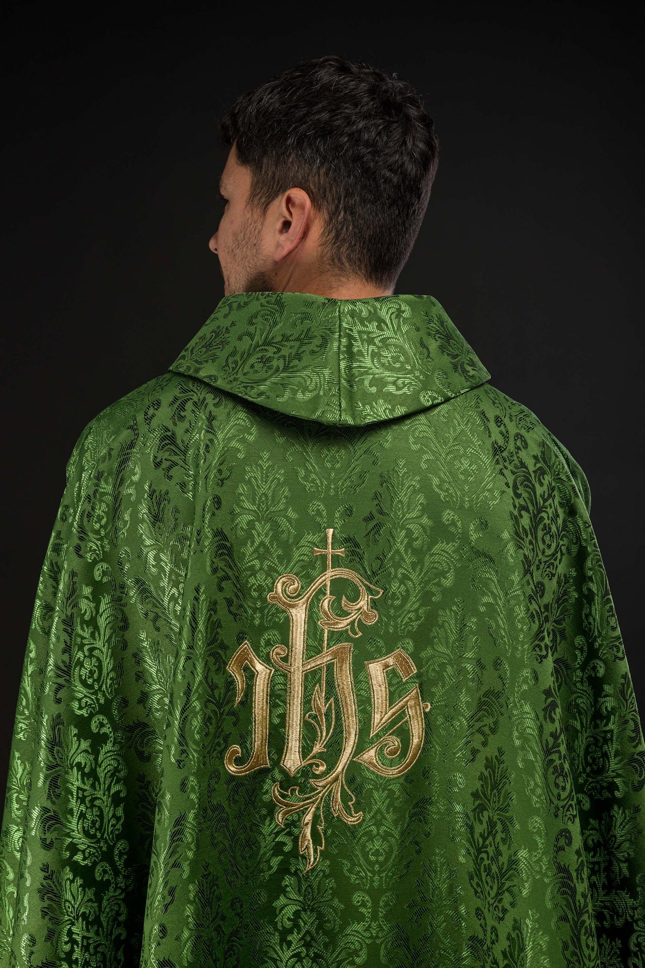 Green chasuble with embroidered IHS motif on decorative fabric