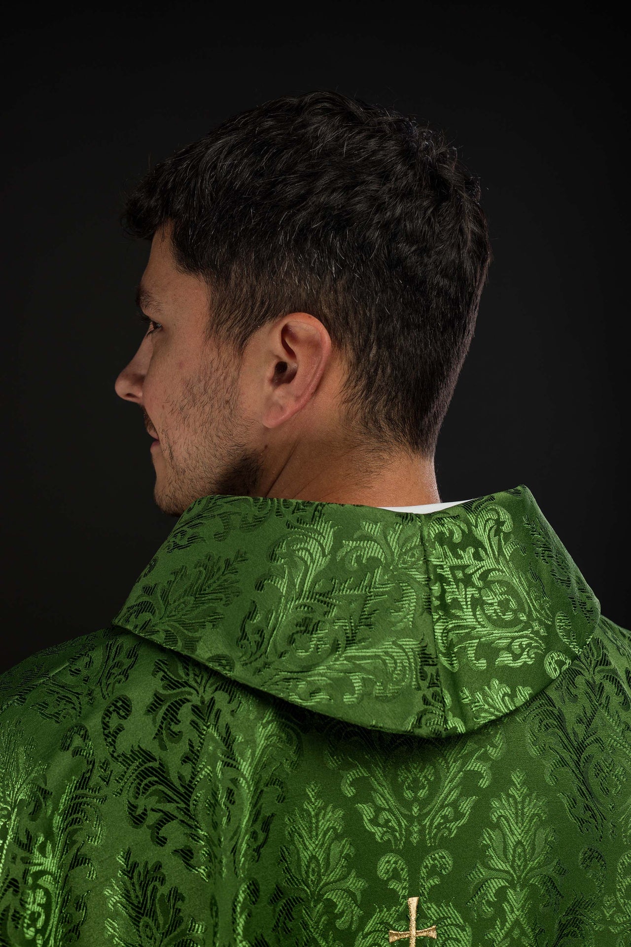 Green chasuble with embroidered IHS motif on decorative fabric