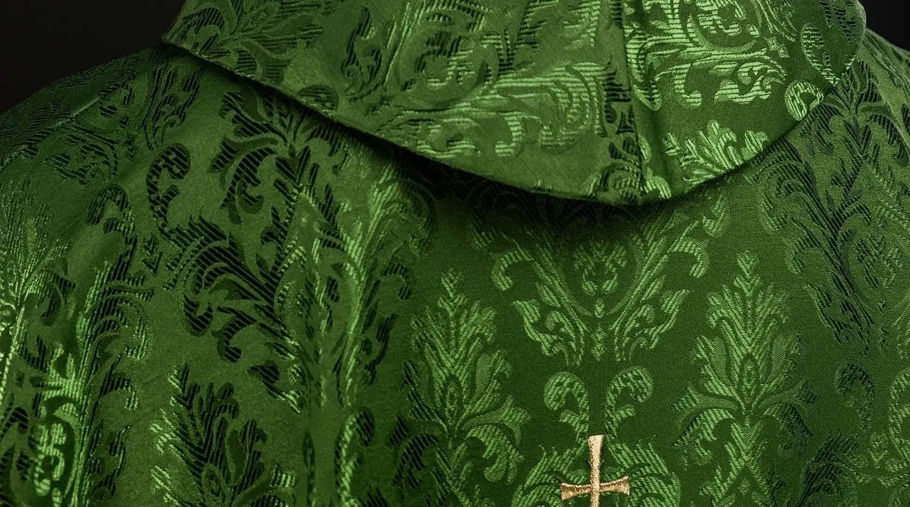 Green chasuble with embroidered IHS motif on decorative fabric