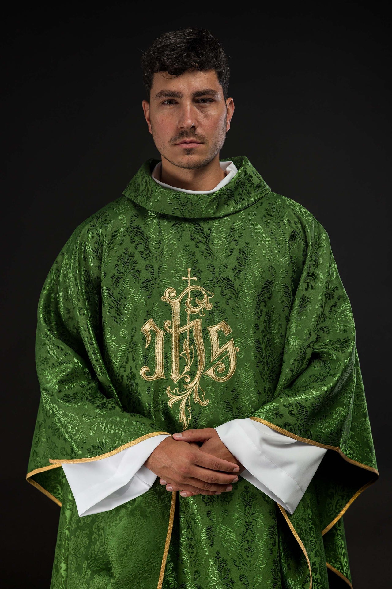 Green chasuble with embroidered IHS motif on decorative fabric