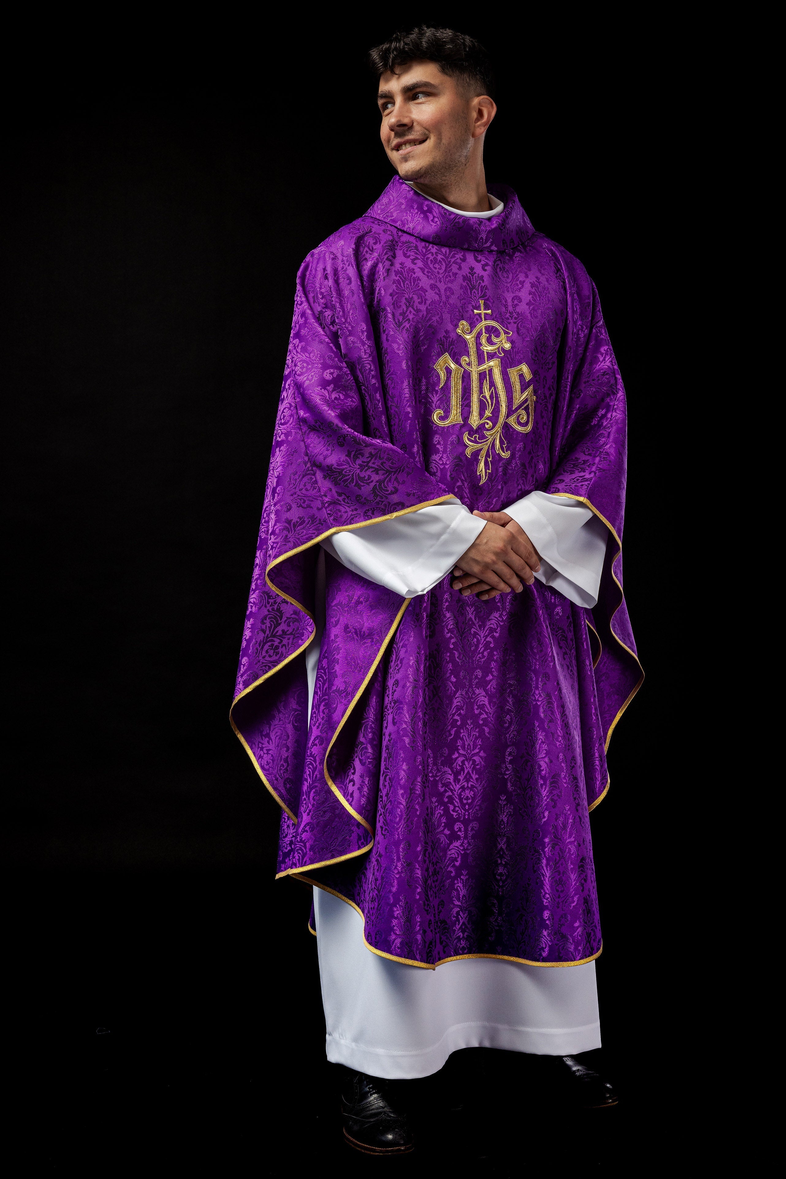 Purple chasuble with embroidered IHS motif on decorative fabric