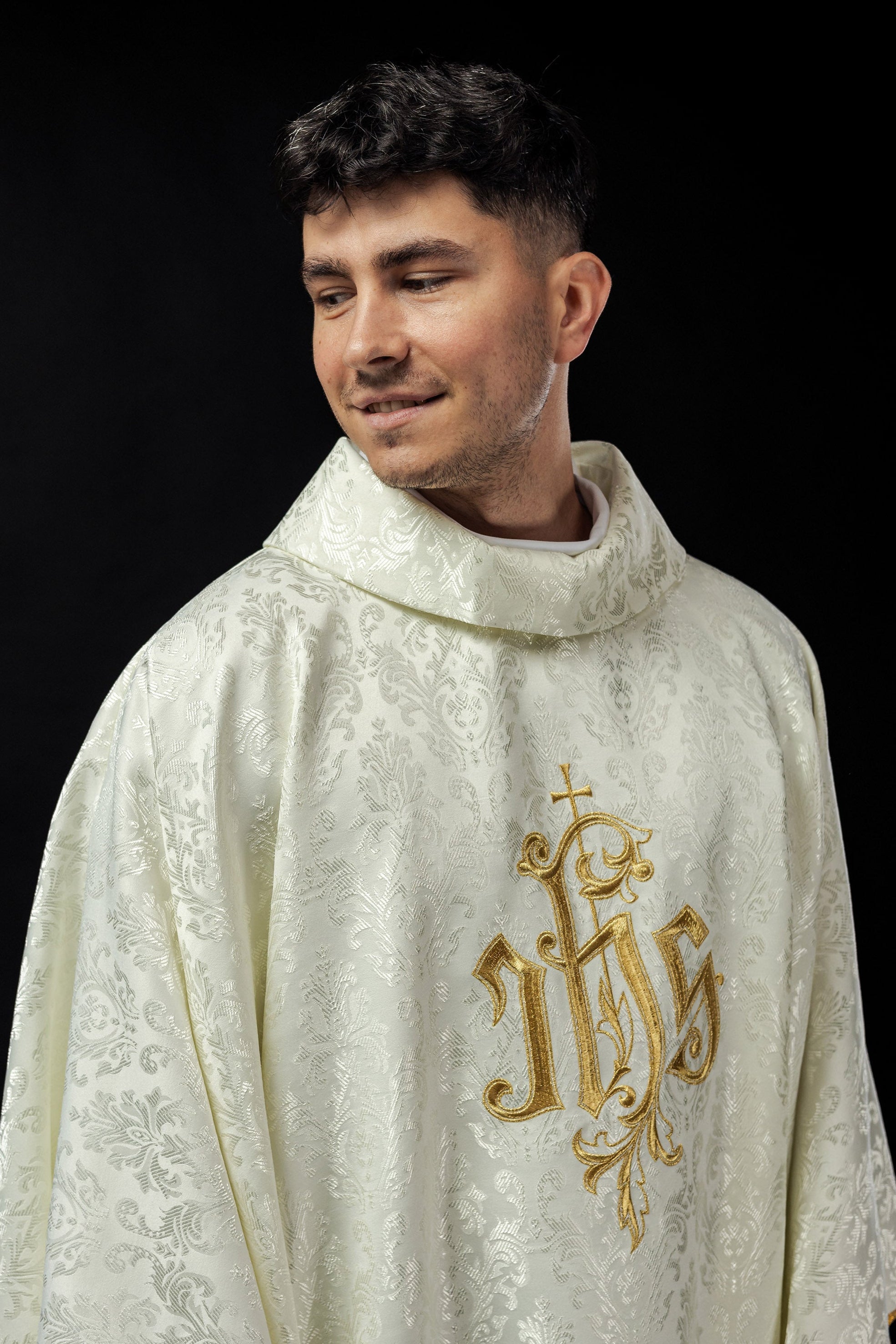 Ecru chasuble with embroidered IHS motif on decorative fabric