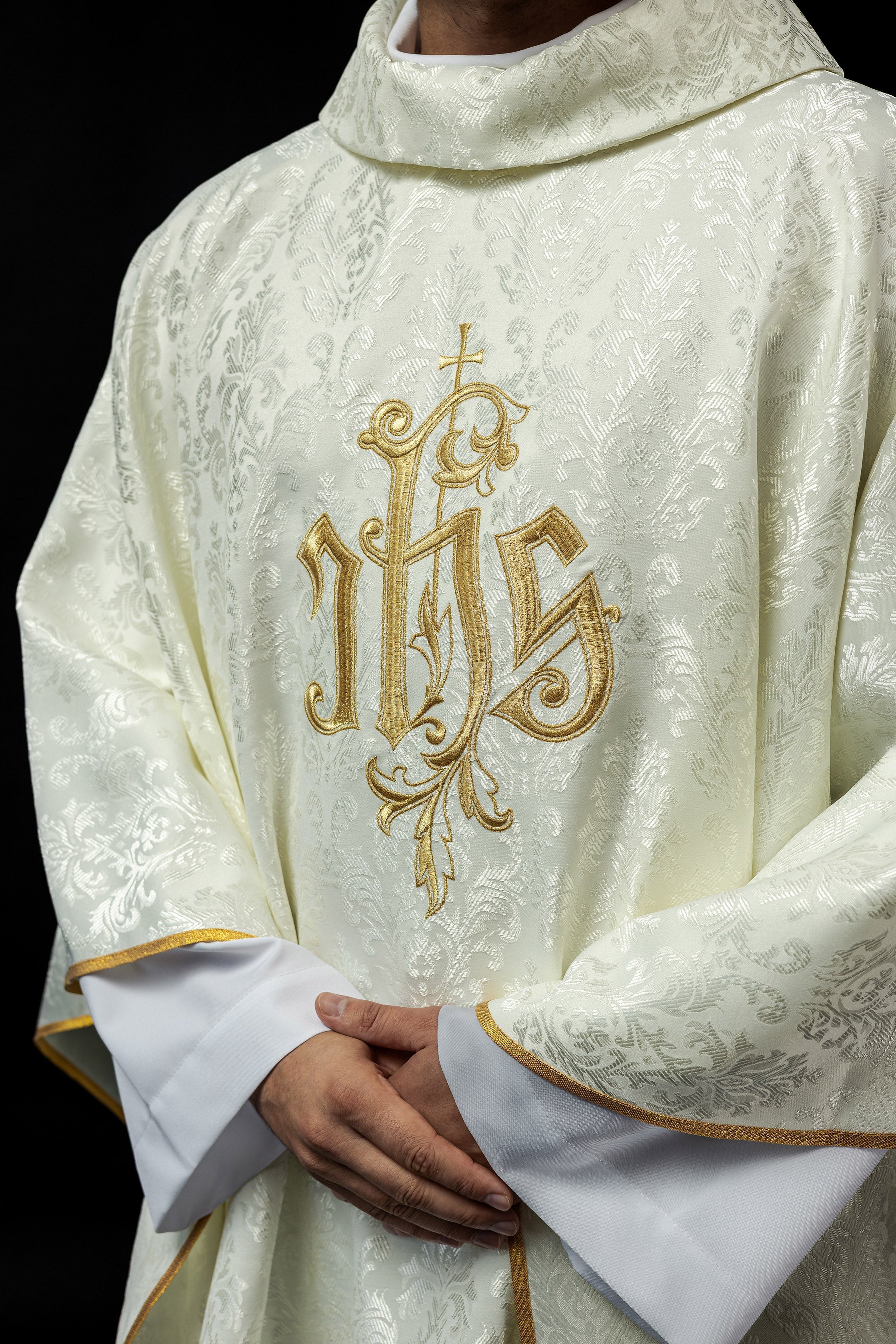 Ecru chasuble with embroidered IHS motif on decorative fabric