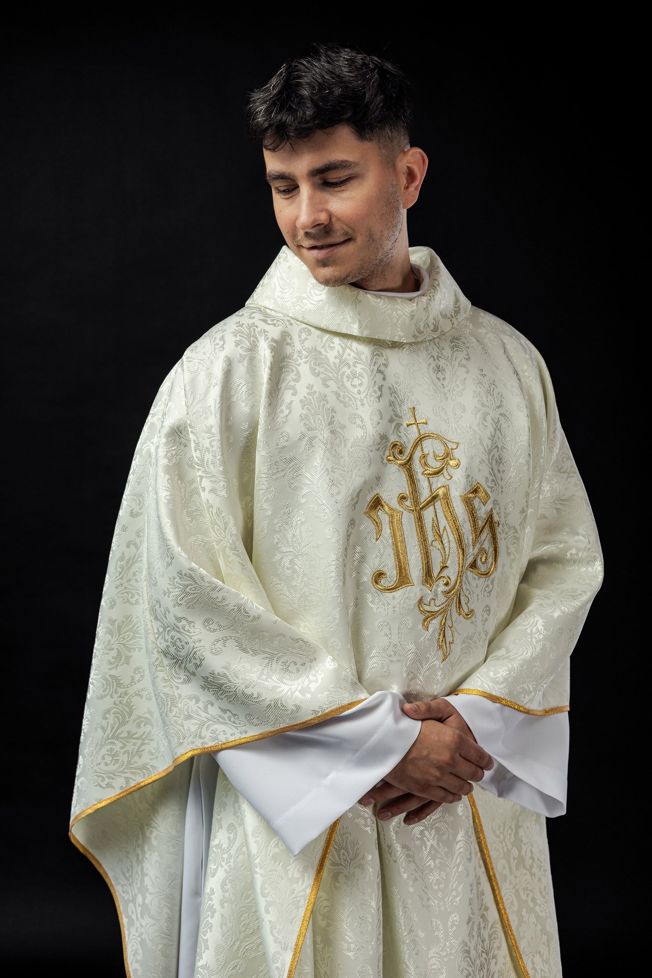 Ecru chasuble with embroidered IHS motif on decorative fabric