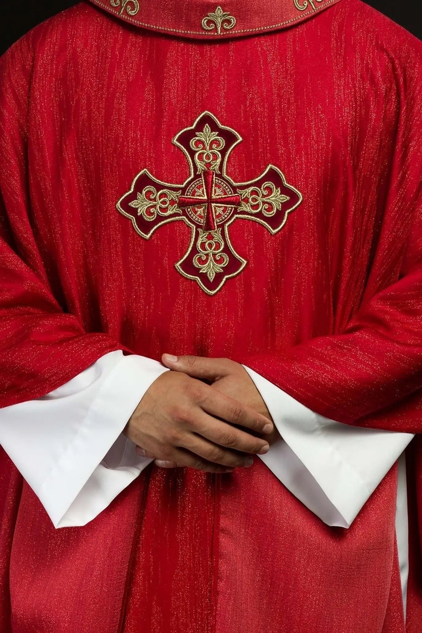 Red chasuble with embroidered cross motif on decorative fabric