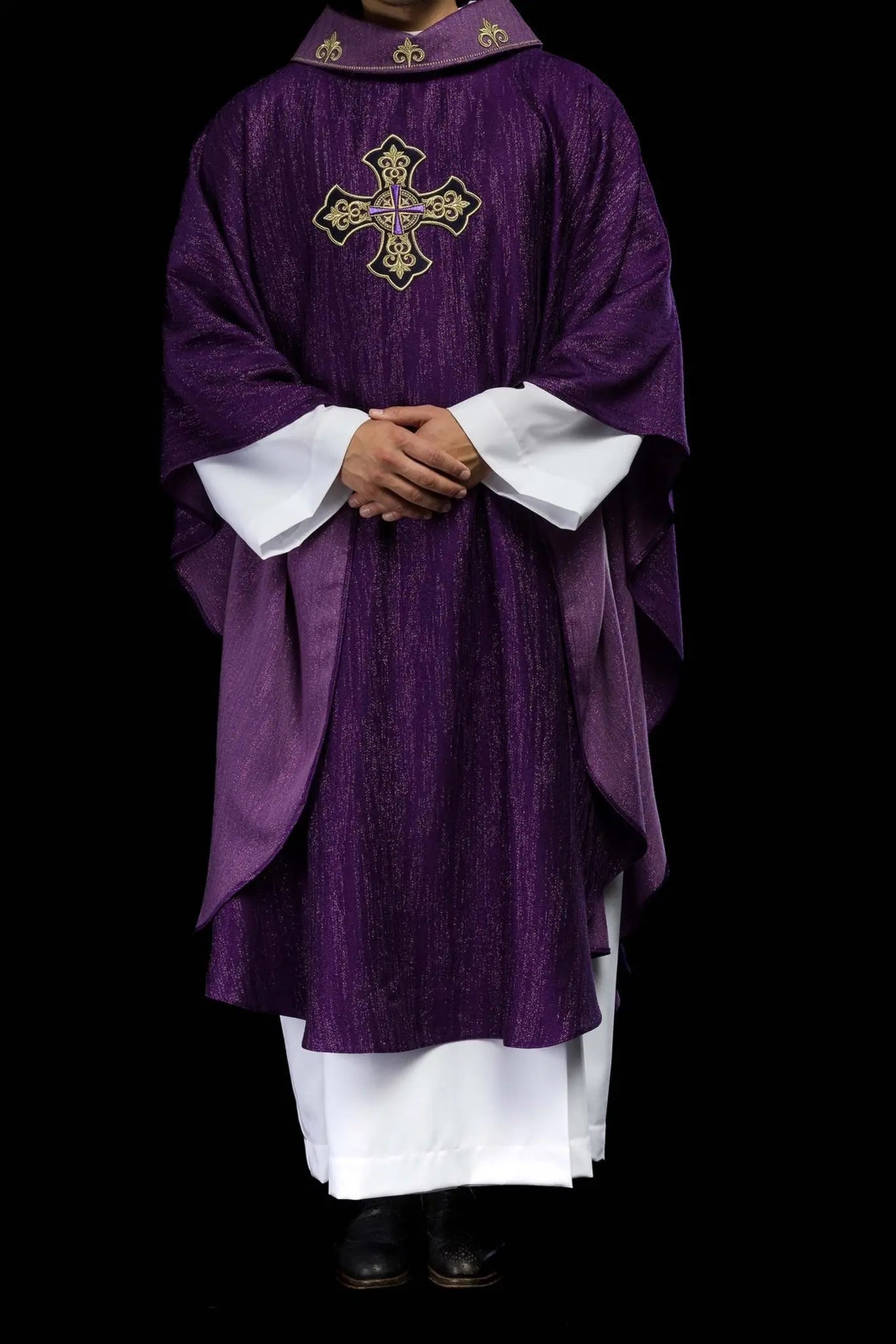 Purple chasuble with embroidered cross motif on decorative fabric