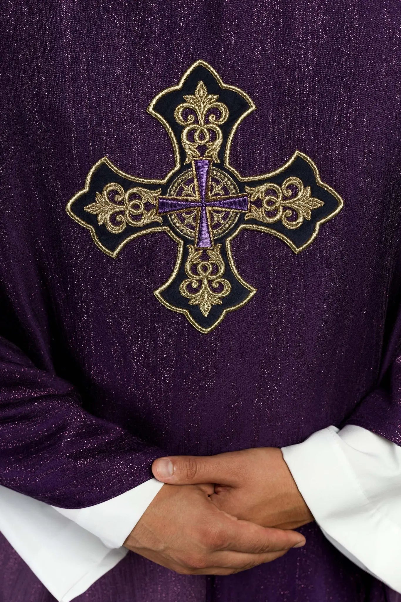 Purple chasuble with embroidered cross motif on decorative fabric