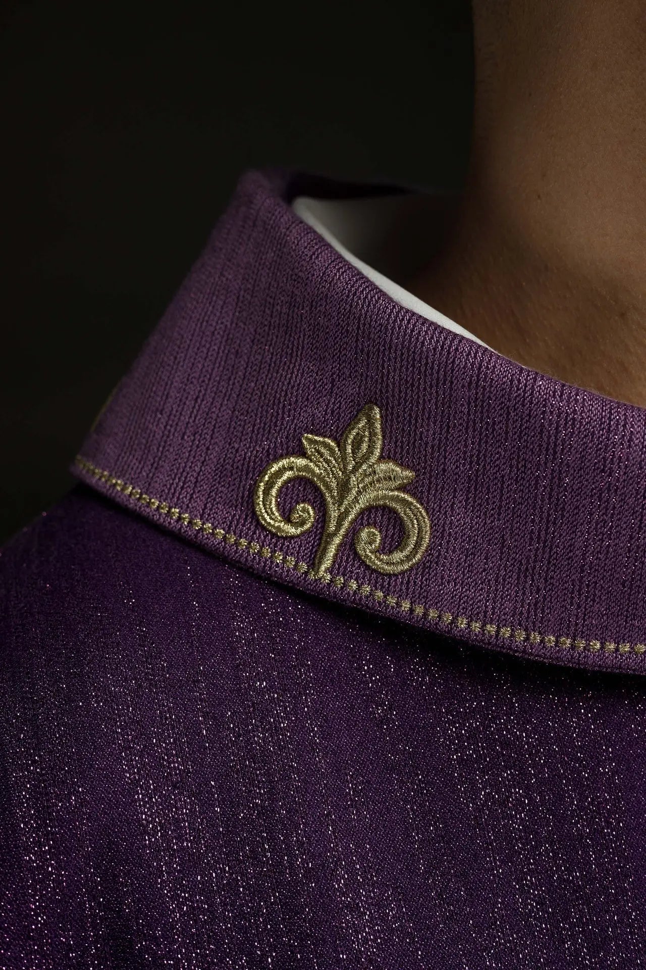 Purple chasuble with embroidered cross motif on decorative fabric
