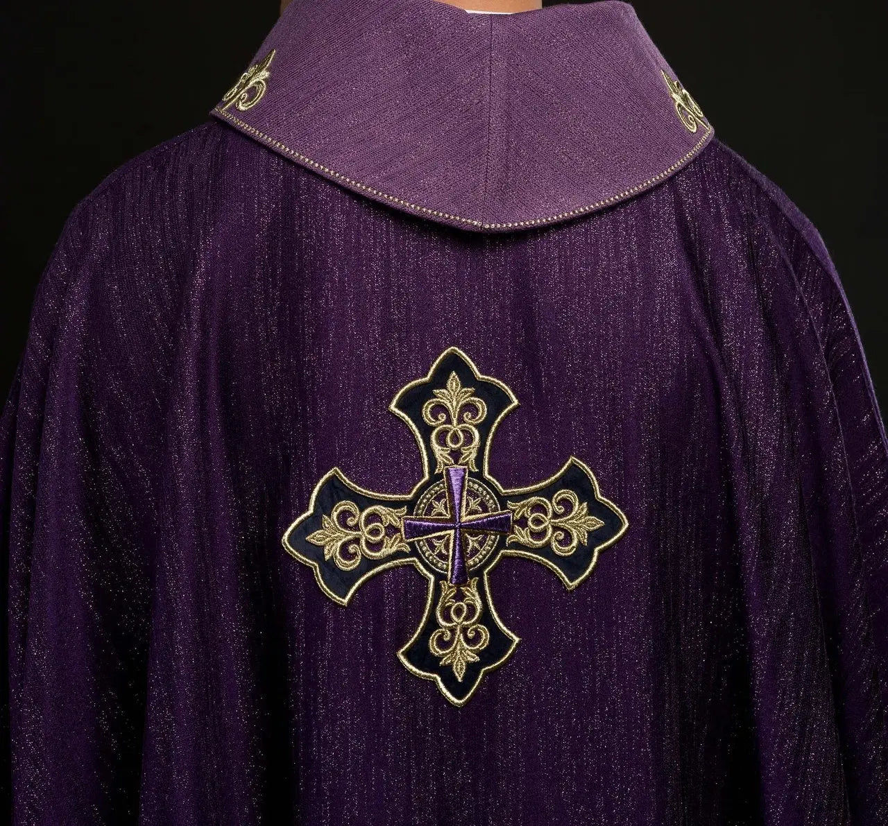 Purple chasuble with embroidered cross motif on decorative fabric