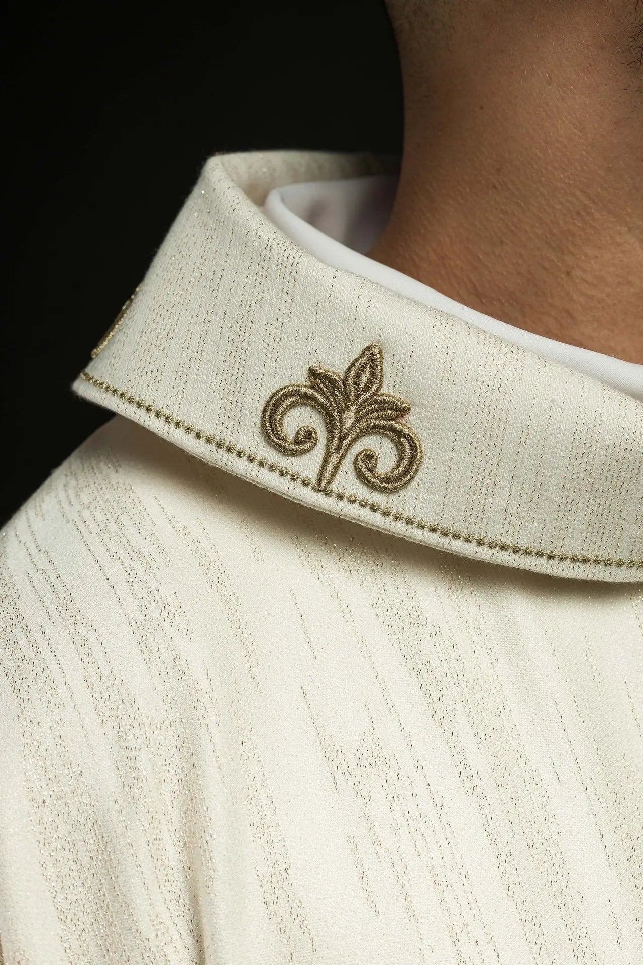 Ecru liturgical chasuble with an embroidered cross motif on decorative fabric