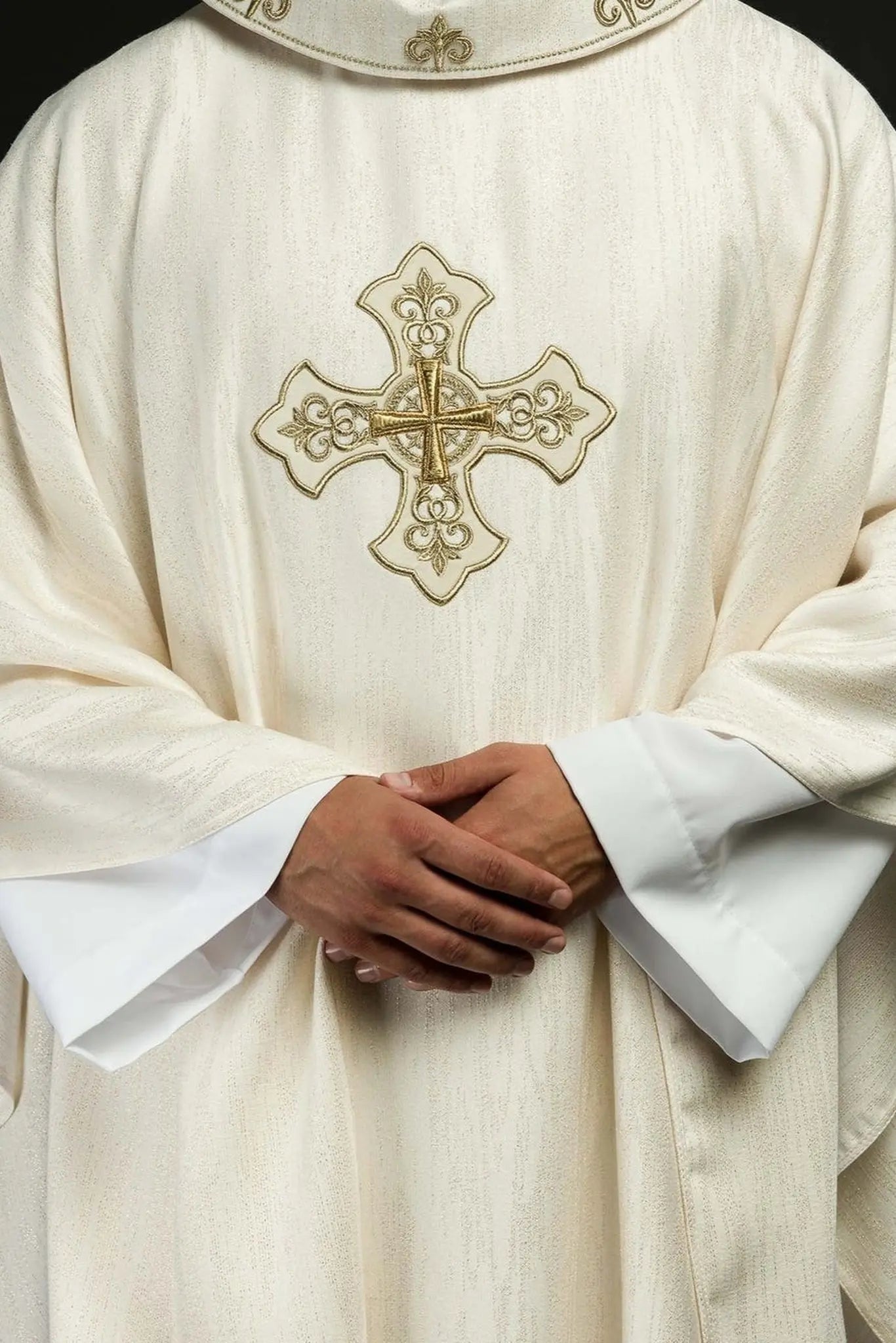 Ecru liturgical chasuble with an embroidered cross motif on decorative fabric