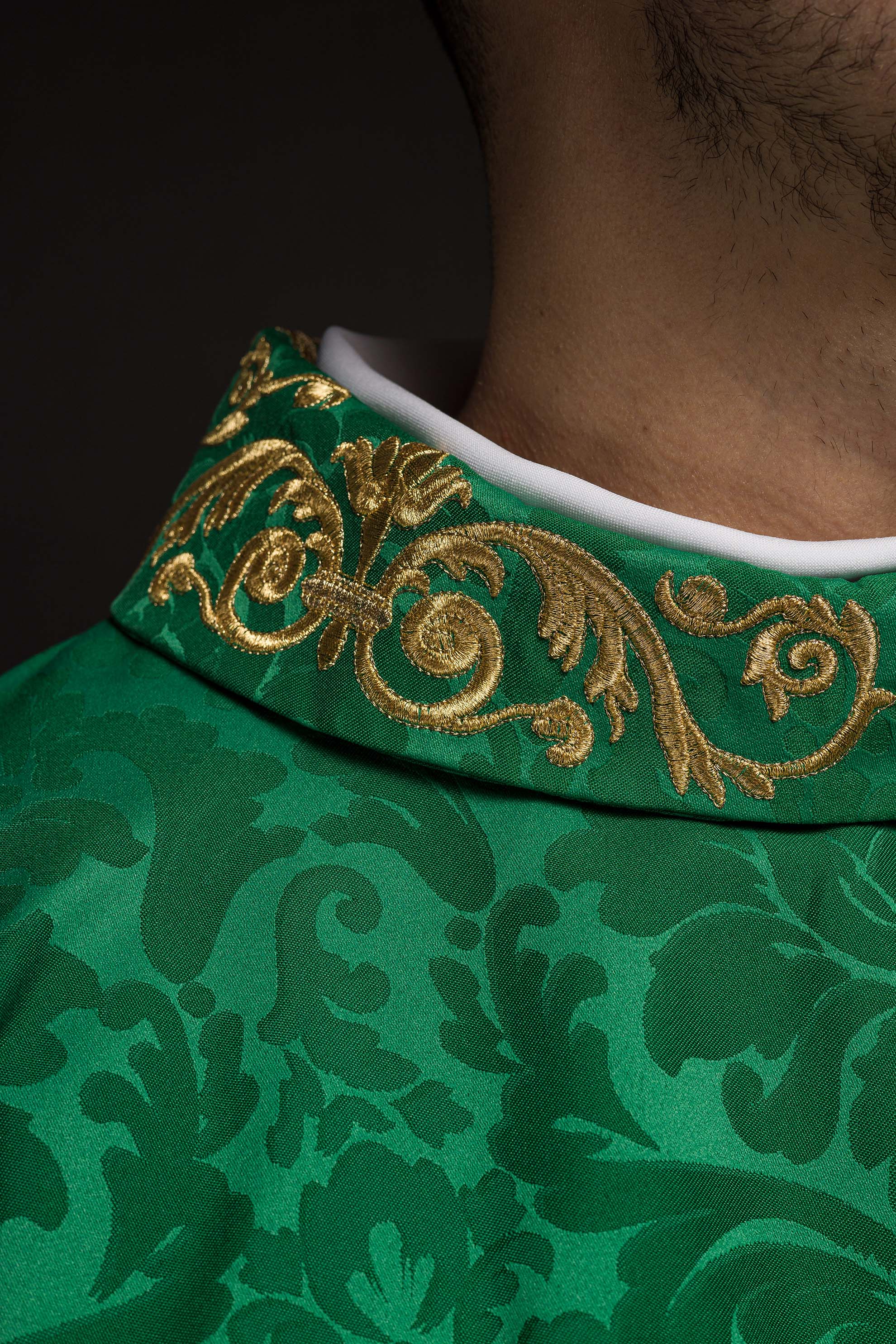 Green chasuble with IHS motif and richly embroidered collar on decorative fabric