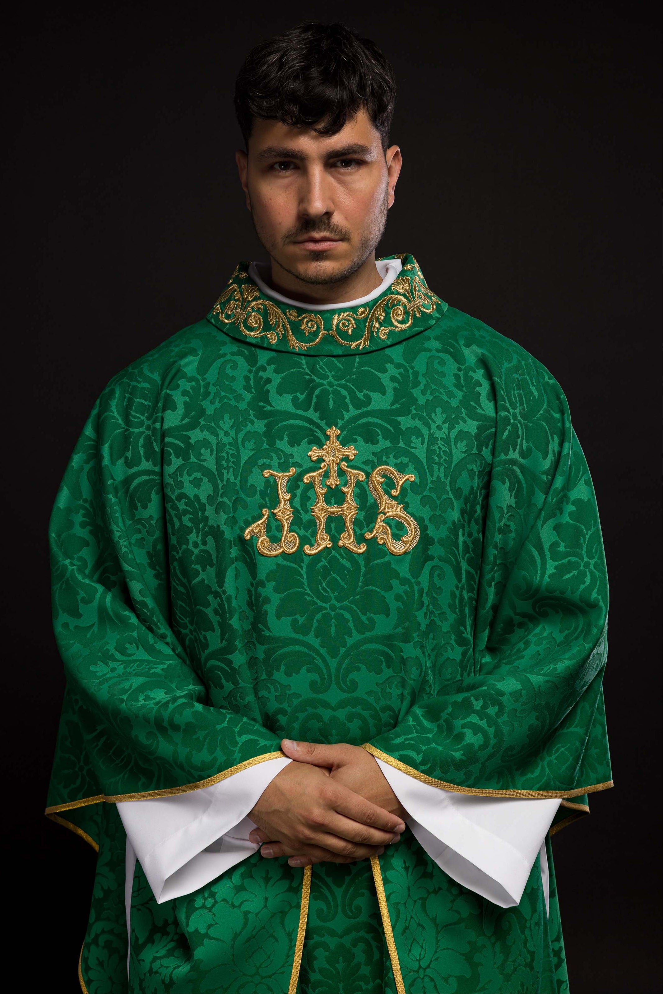 Green chasuble with IHS motif and richly embroidered collar on decorative fabric