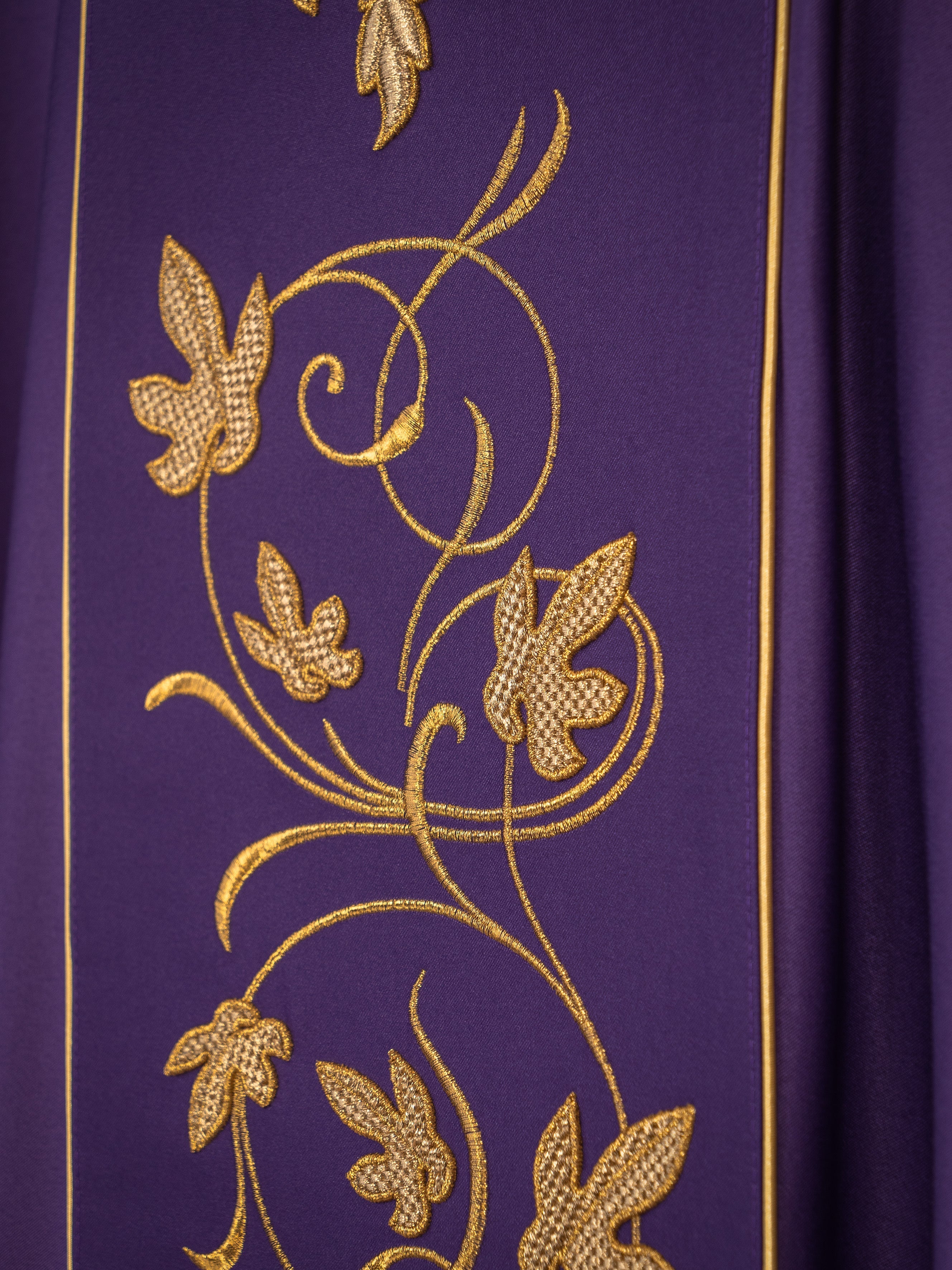 Purple liturgical chasuble with richly decorated belt with floral motif and IHS