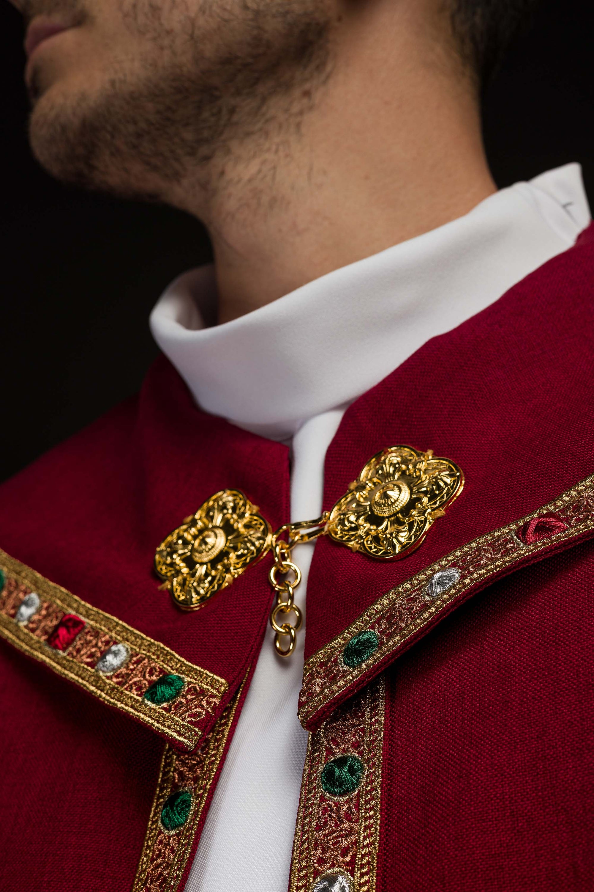 Red liturgical cape with gold IHS