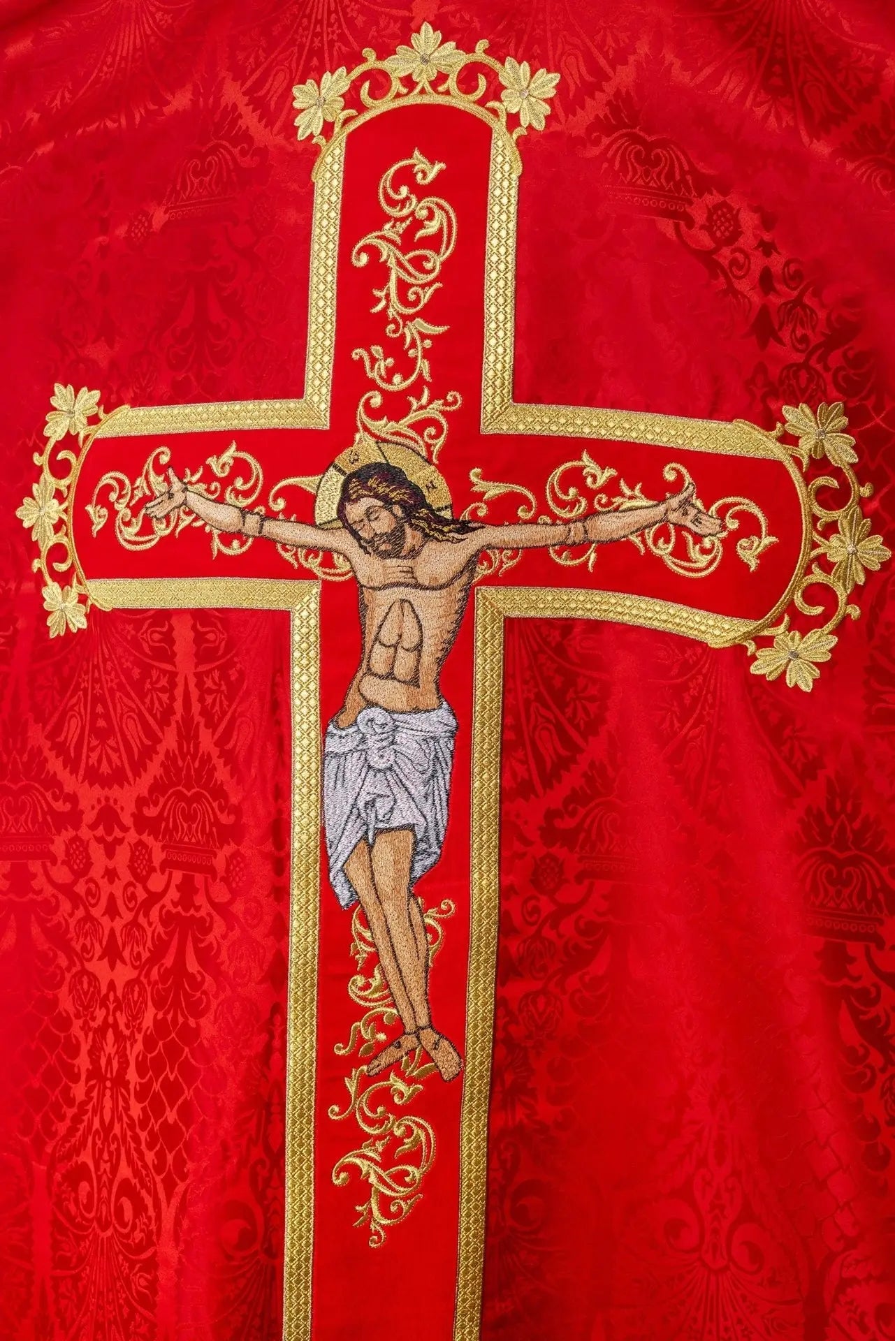 Red chasuble embroidered with the pattern of Jesus Christ