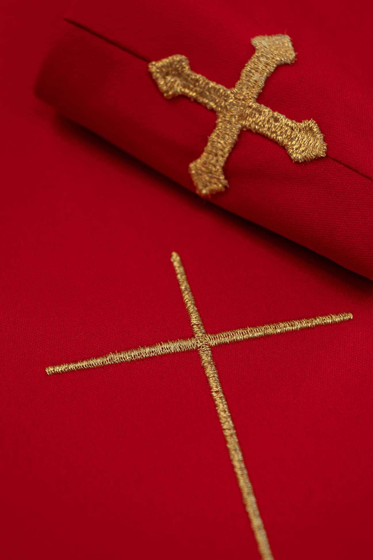 Red chasuble embroidered with IHS chalice design