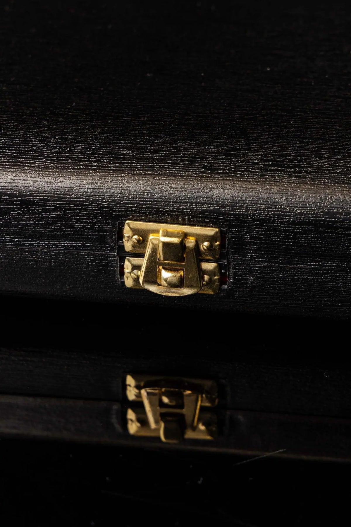 Black liturgical equipment burse with gold clasp, clasp close-up view