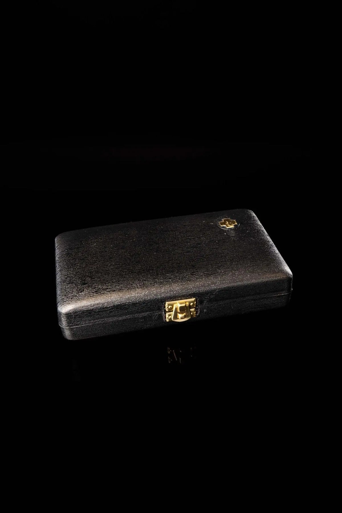 Black liturgical equipment burse with gold cross emblem, closed view