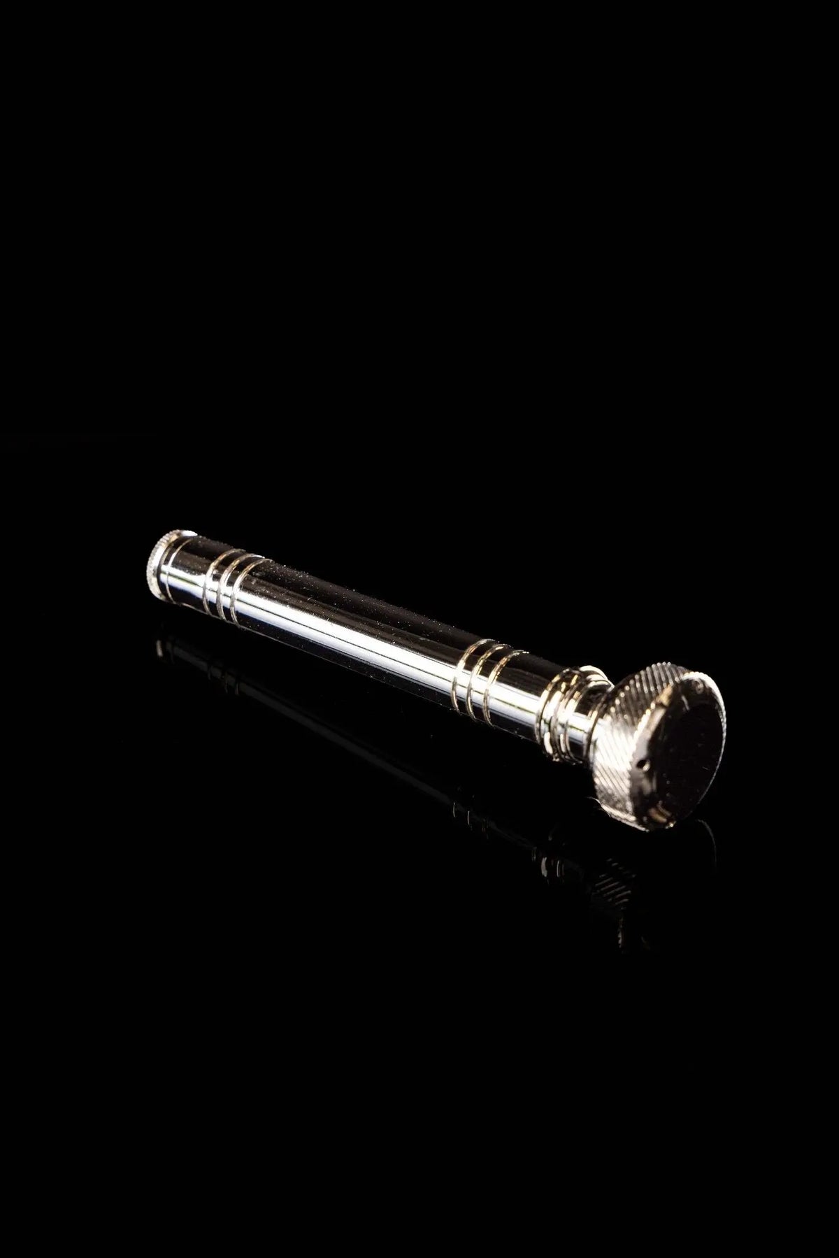 Silver aspergillum with polished handle and ridged end cap, side view