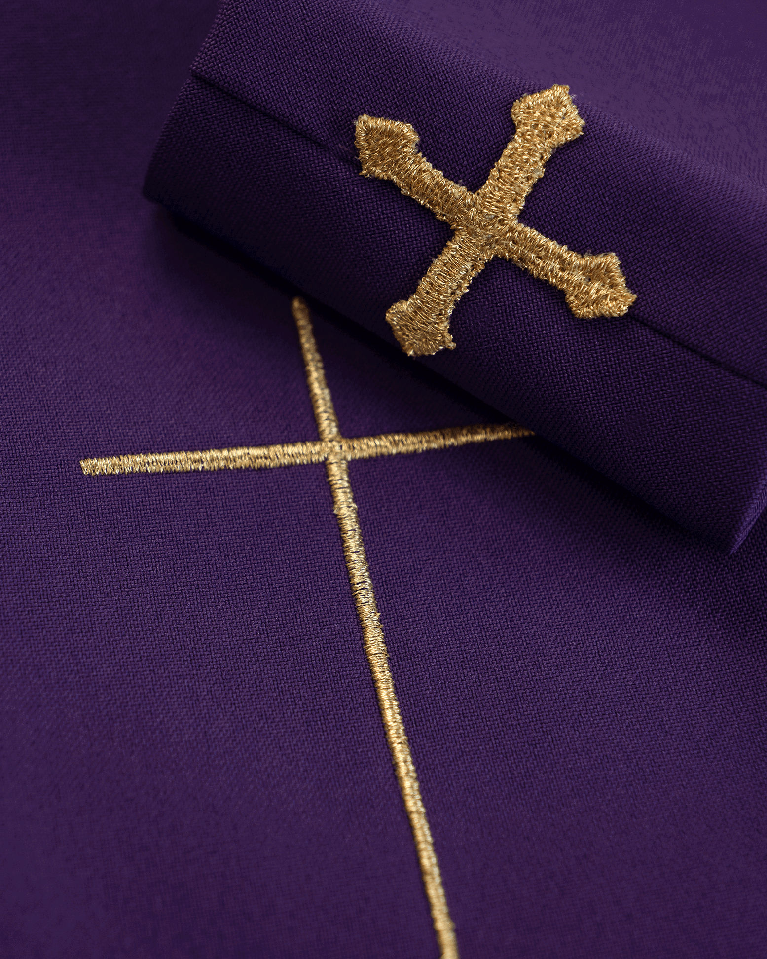 Purple liturgical chasuble decorated with embroidery on velvet