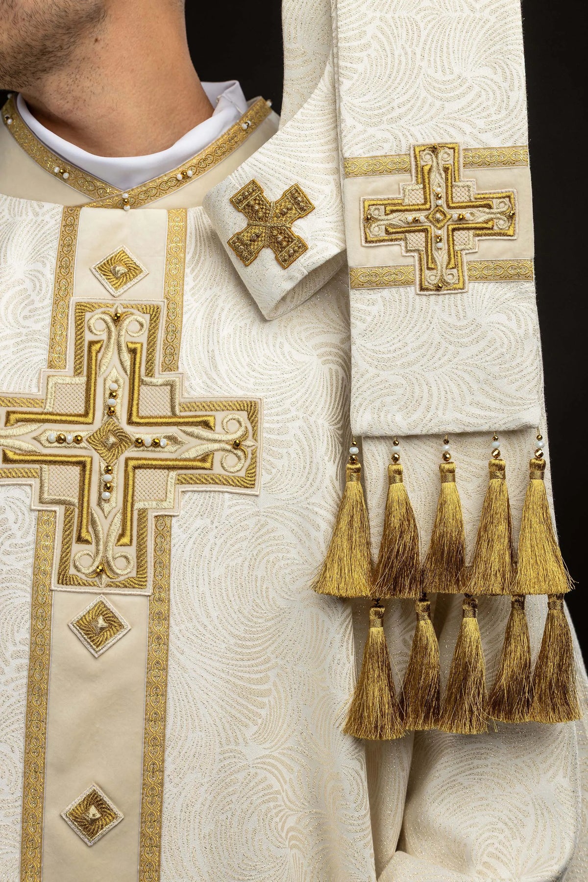 Ecru Easter chasuble with embroidered cross and gold tassels, detail view