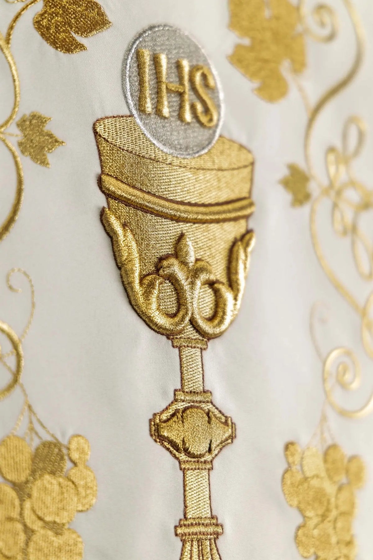Ecru lectern cover with embroidered gold chalice and IHS emblem, close-up