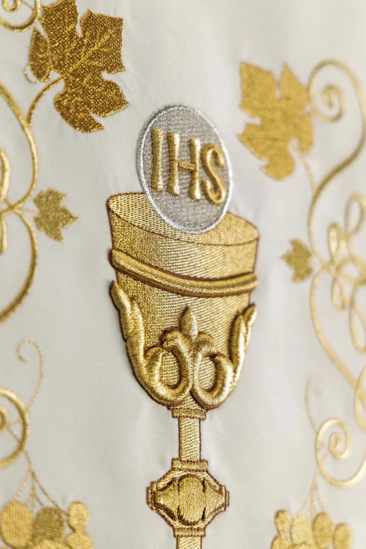 Ecru lectern cover with embroidered IHS chalice and grapevines, close-up